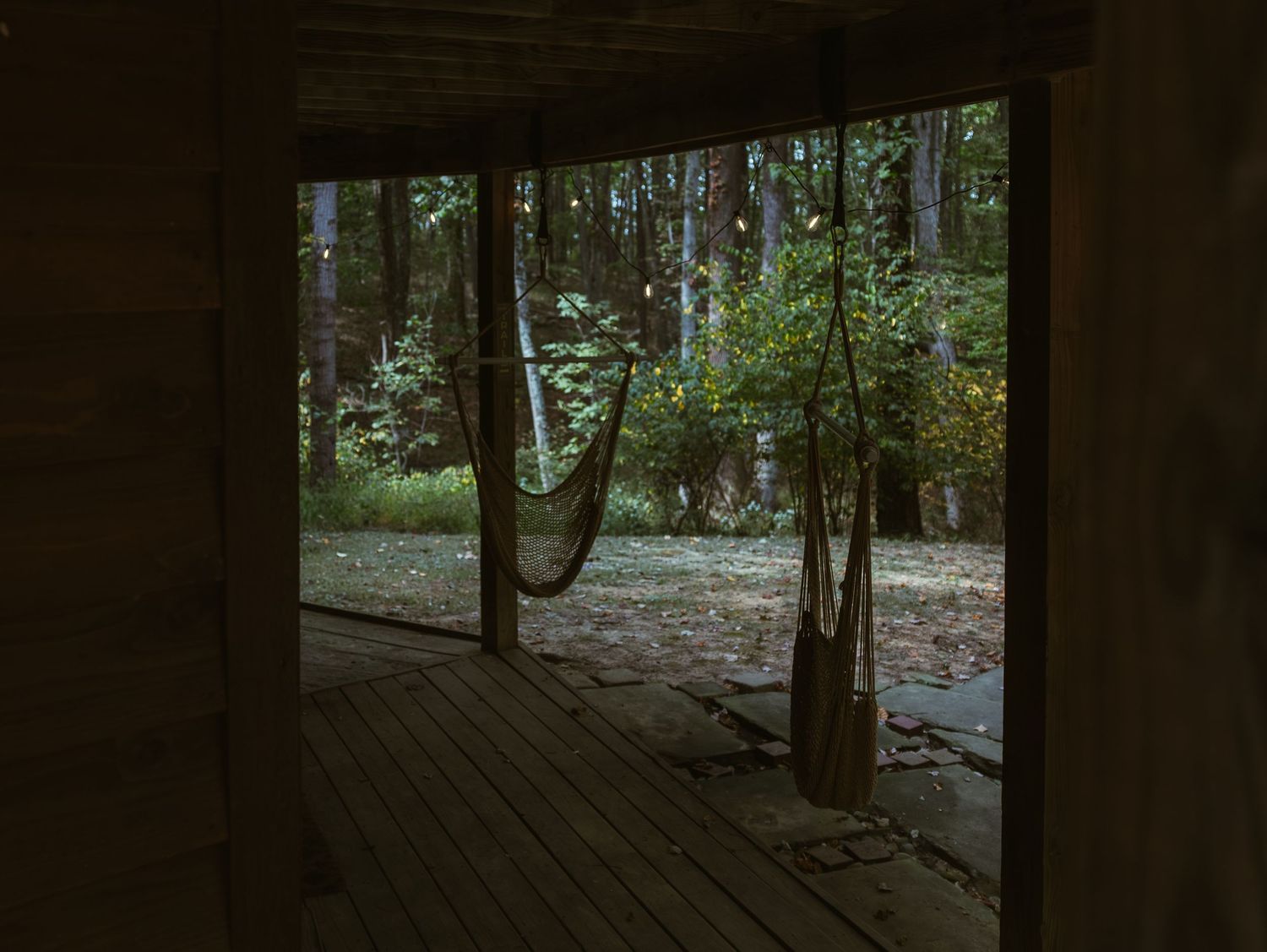 Wooden deck pathway through a misty forest setting.