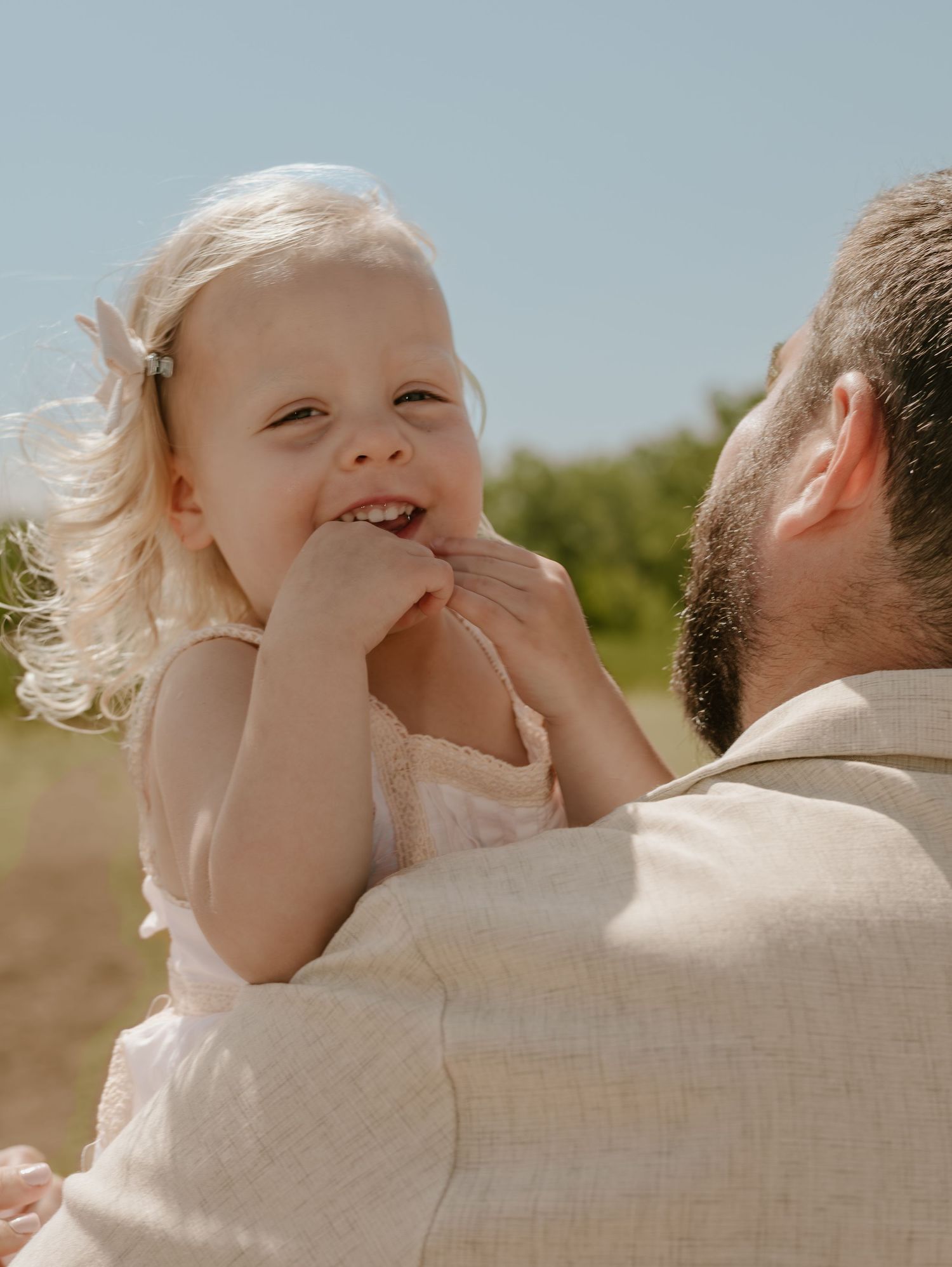 Series of tender moments captured between a parent and child on a sunny summer day.