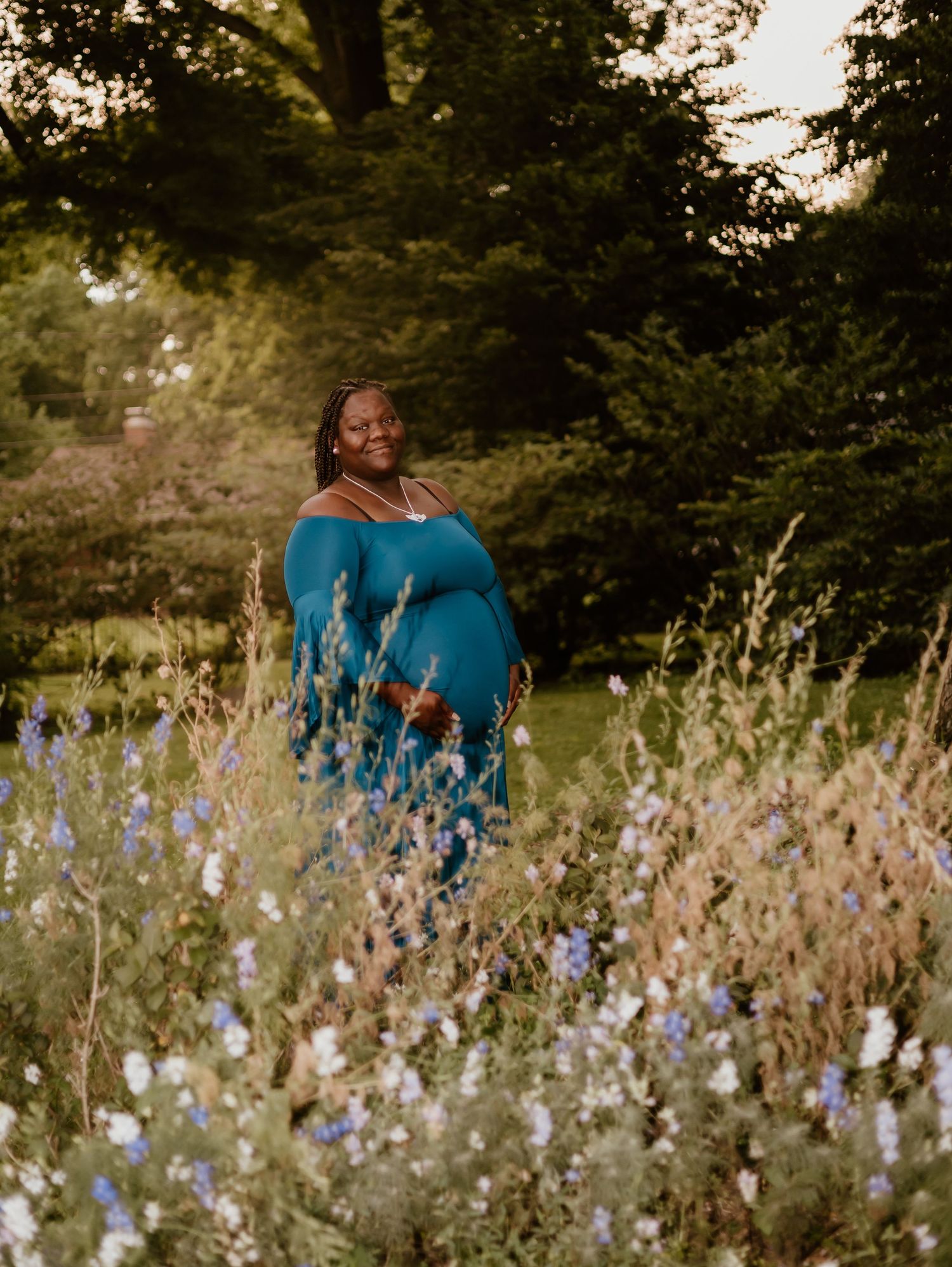 A peaceful meadow filled with delicate purple and white wildflowers swaying in the summer breeze at sunset.