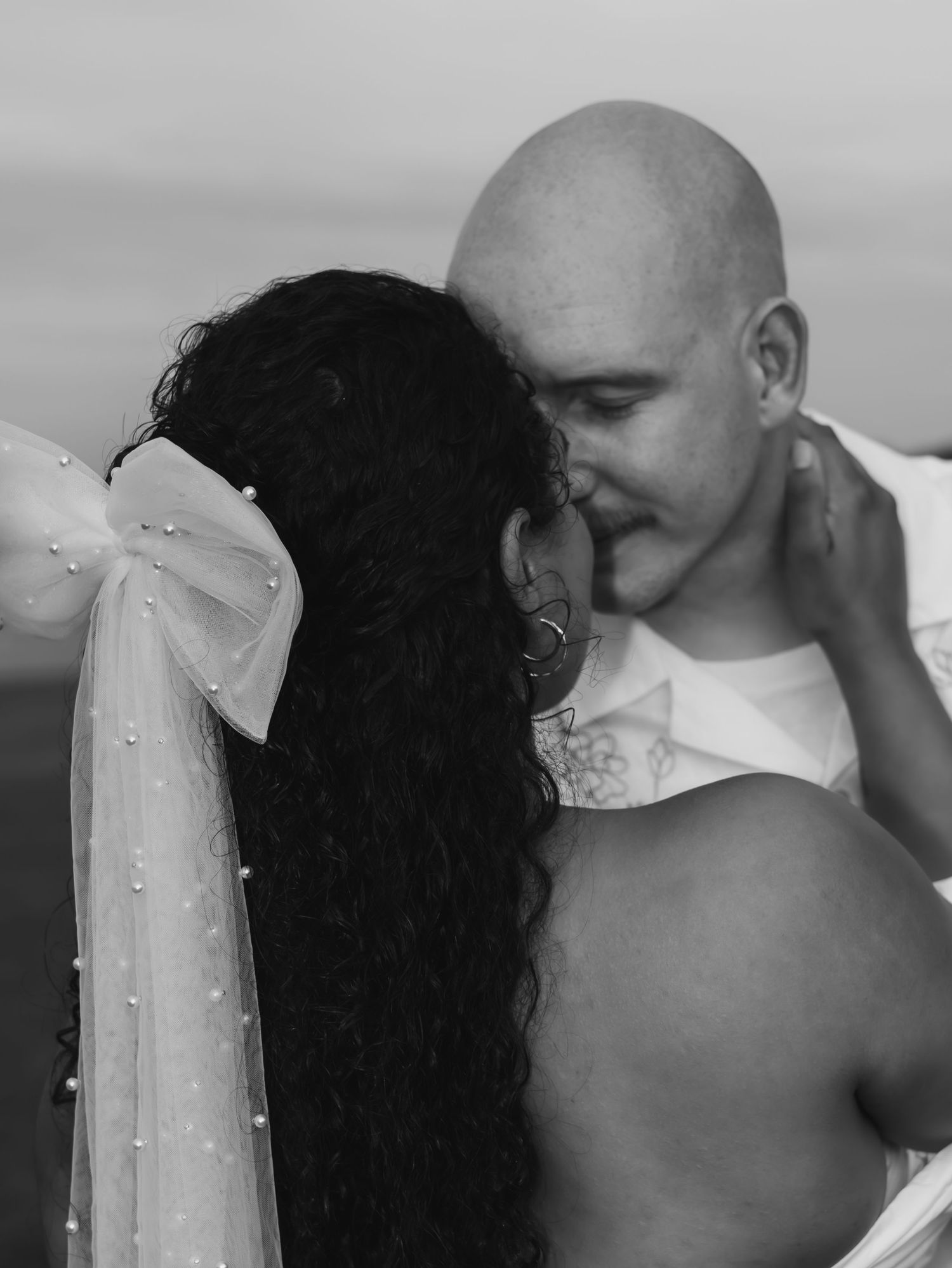 A romantic black and white photo series showing a couple embracing in multiple intimate poses.