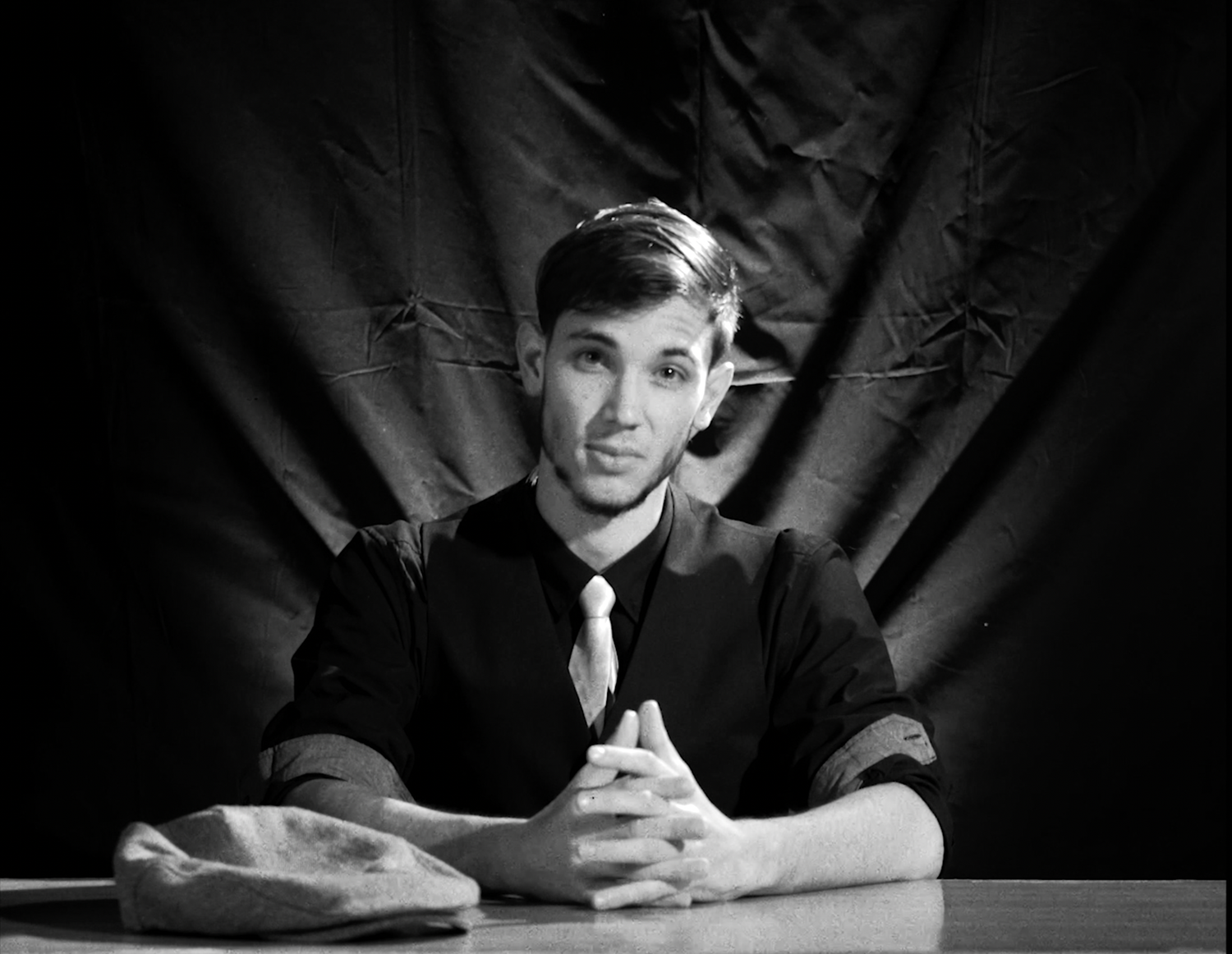 Black and white moody atmospheric portrait series showing dramatic shadows and dark backgrounds with simple lighting.