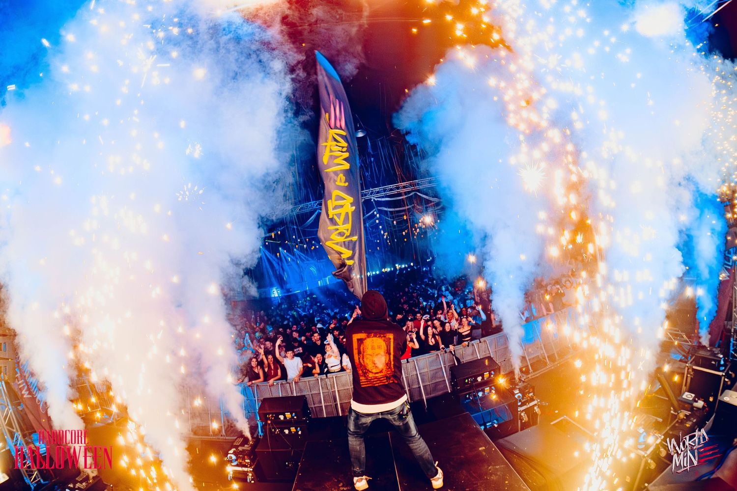 Concert performance with dramatic pyrotechnic effects and smoke creating an intense atmosphere.