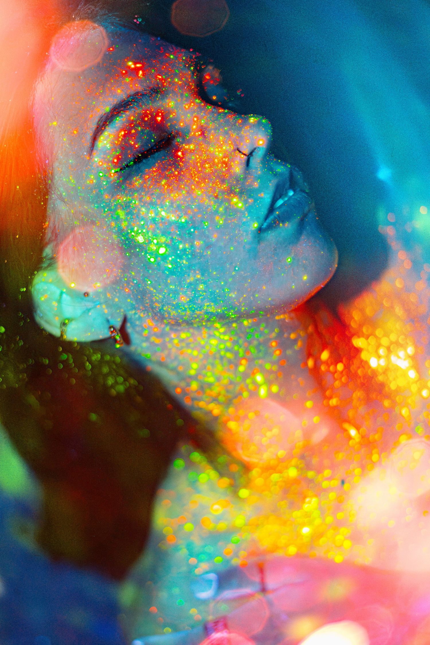 Vibrant macro photograph of colorful opal gemstone displaying iridescent flashes of blue, orange, and green fire patterns.
