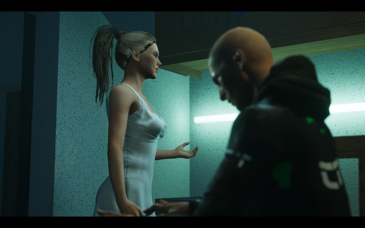 Three still frames show a person in dark clothing walking down a dimly lit corridor with blue-tinted lighting.