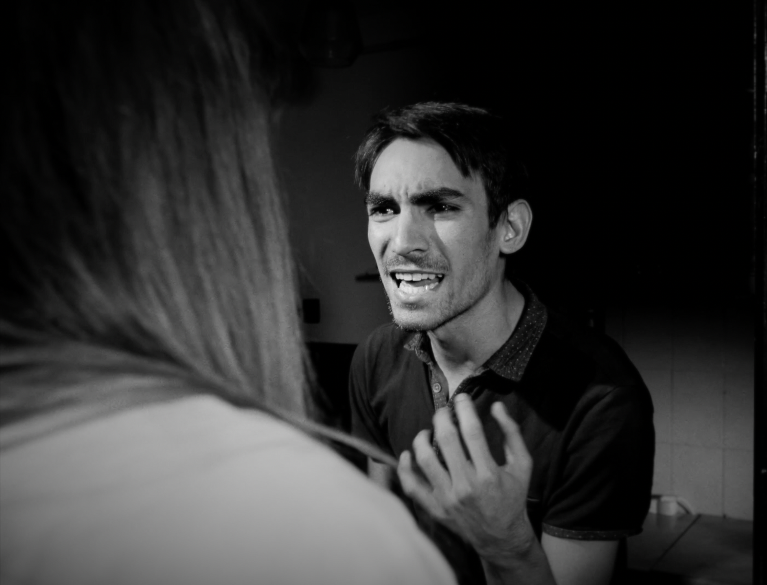 A dramatic black and white photo series showing moments of contemplation and emotion in a dark setting.