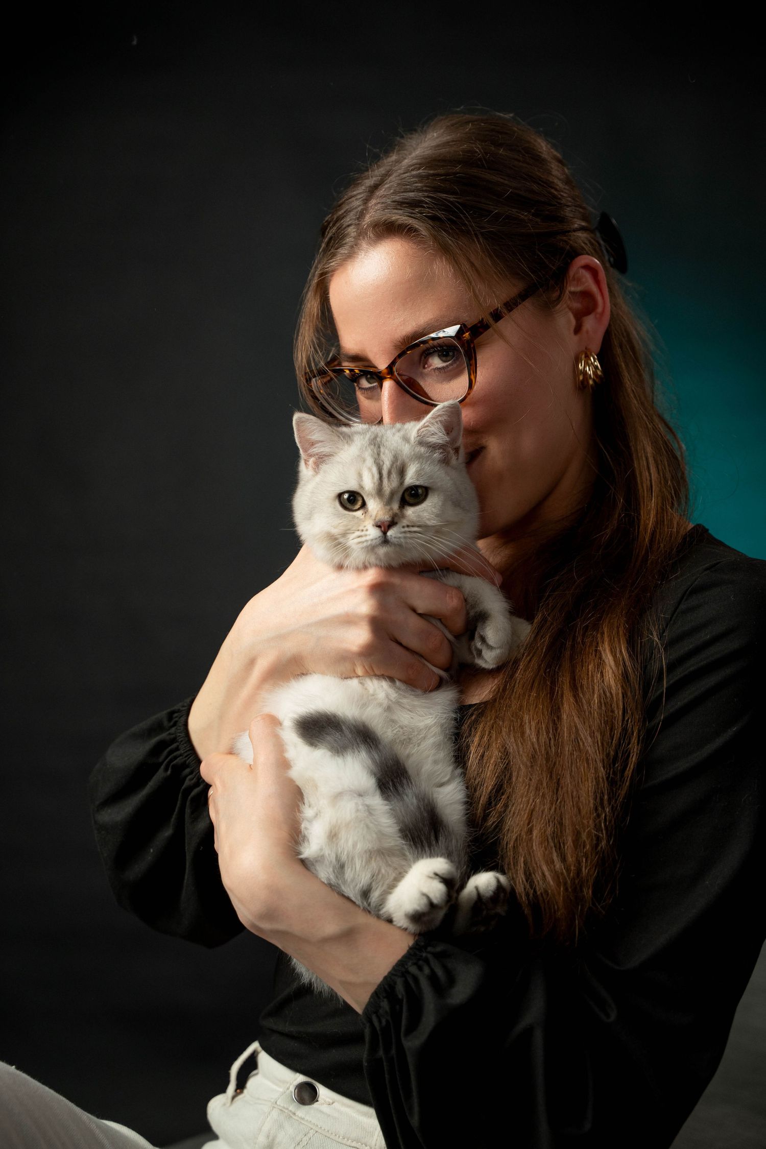 Portrait with white Persian cat against dark background with teal accent lighting.
