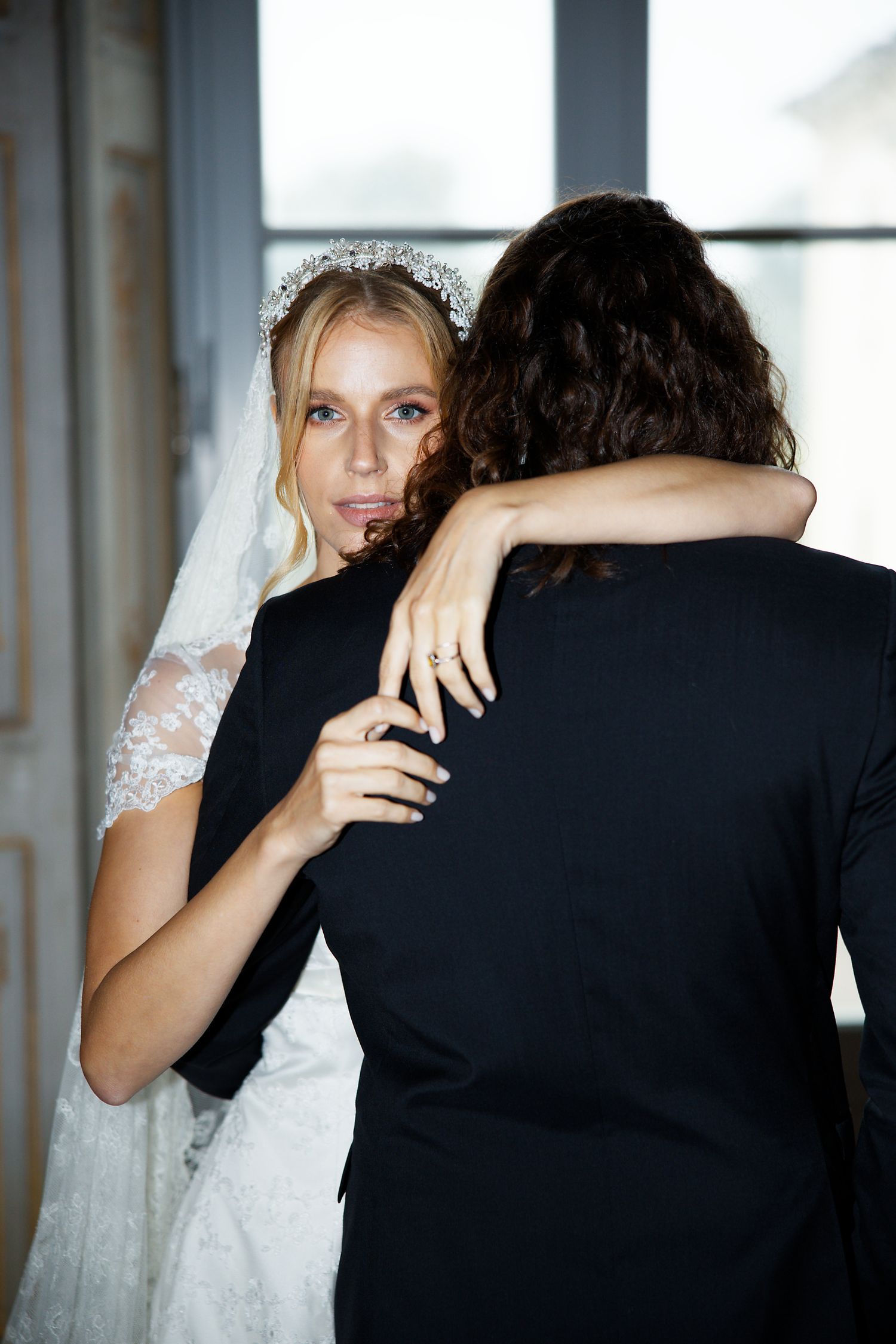 An intimate moment captured as a couple embraces during their wedding celebration.