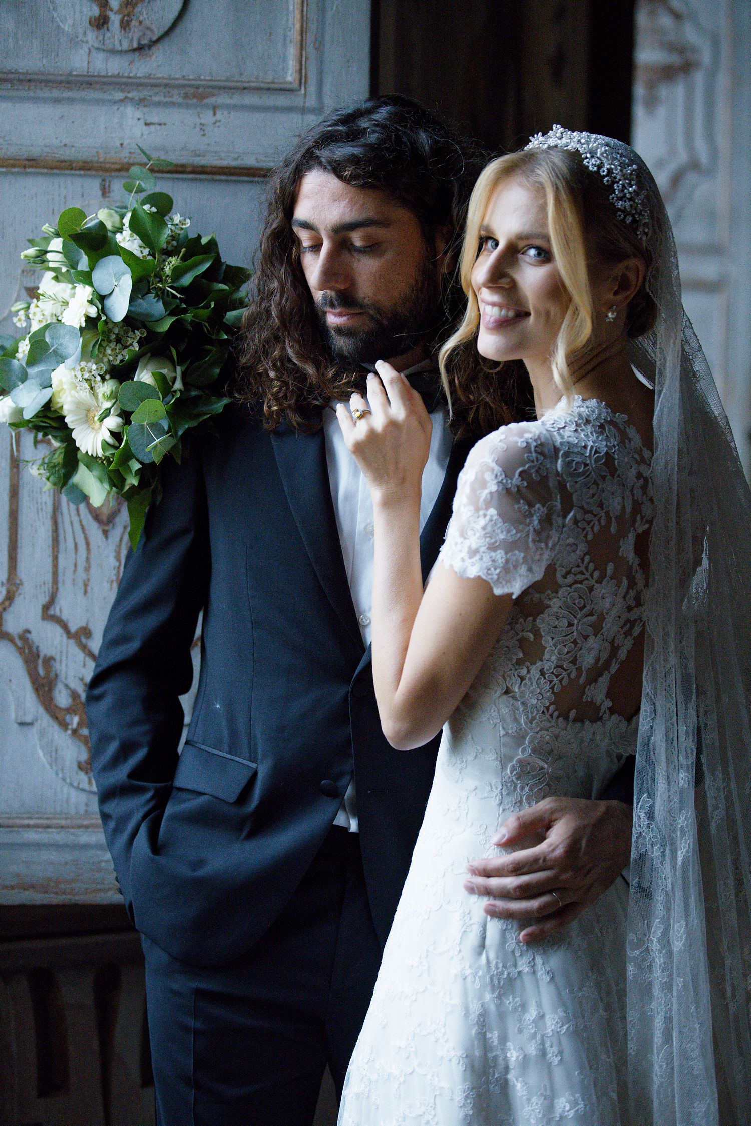 An intimate wedding portrait showcasing elegant bridal details and formal attire.