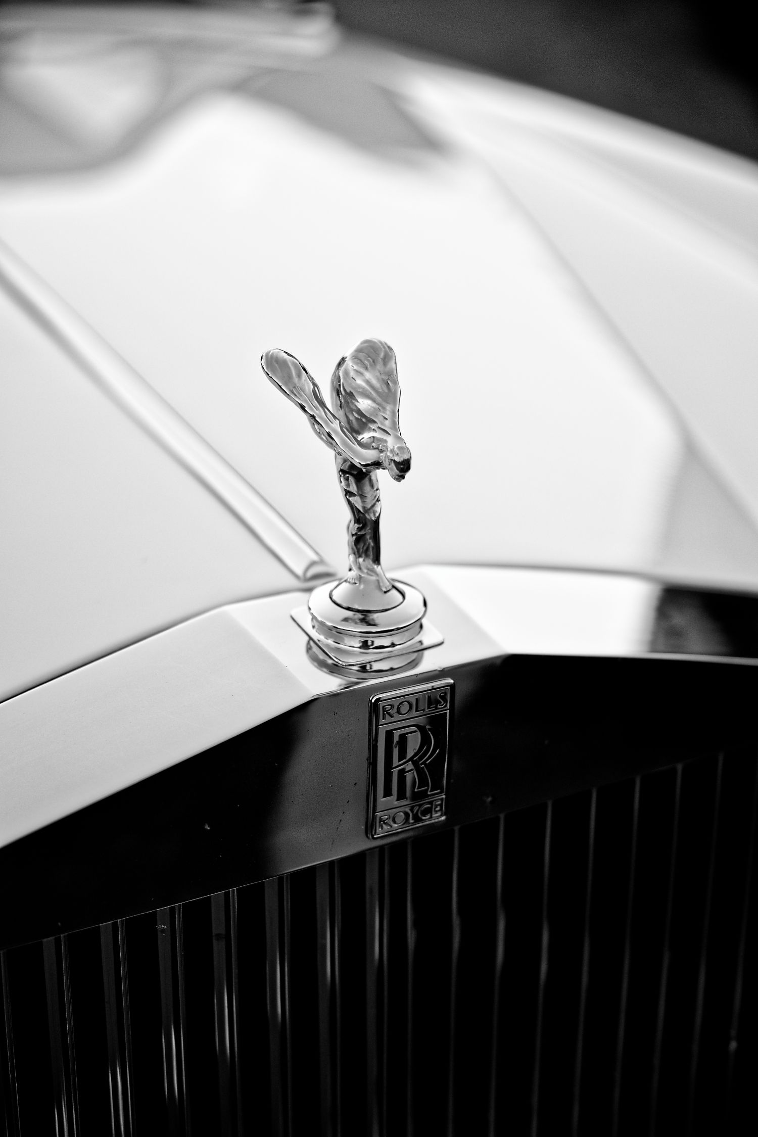 Classic Rolls-Royce Spirit of Ecstasy hood ornament captured in black and white.