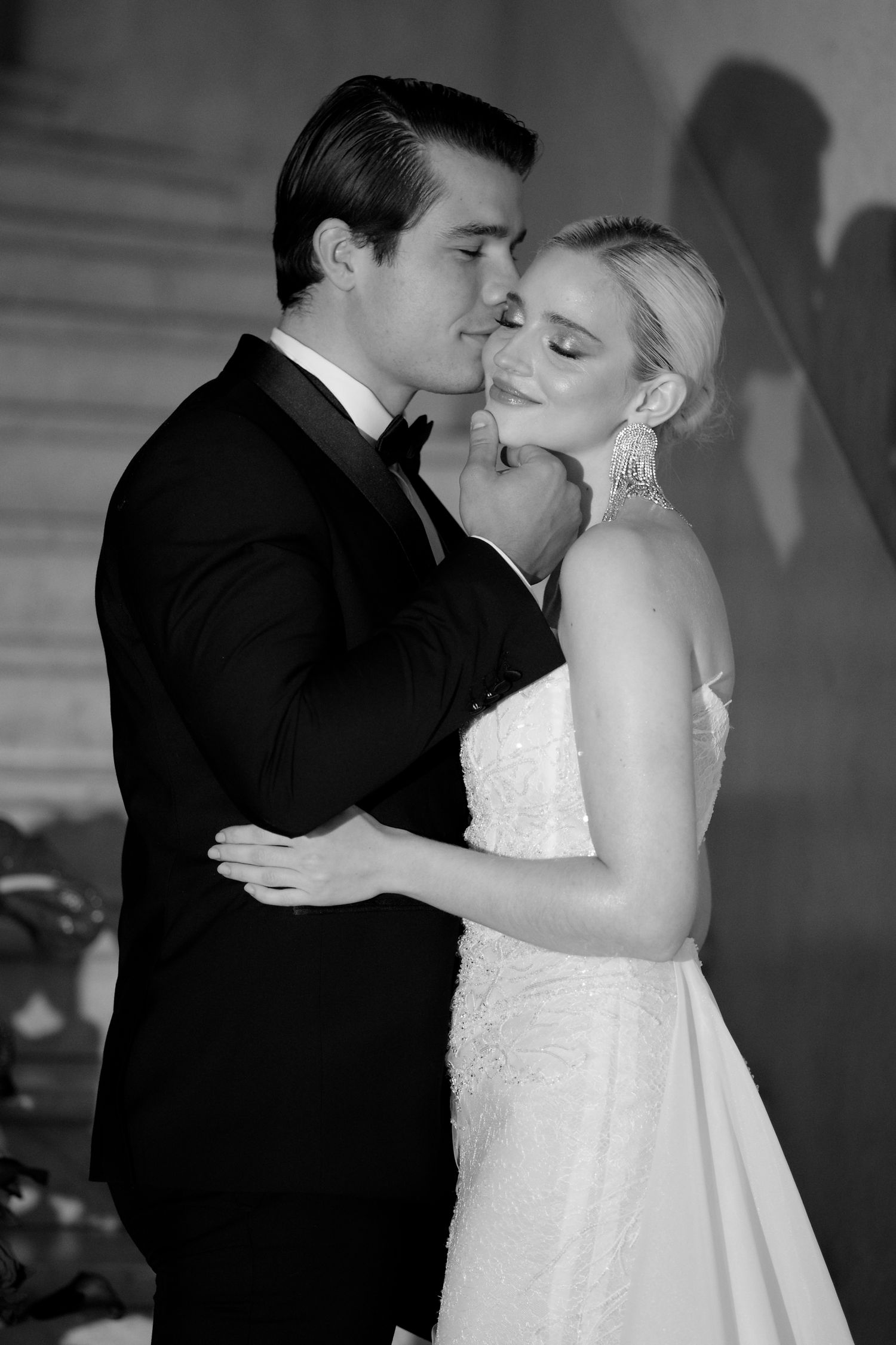 Intimate black and white portrait of newlyweds sharing a close embrace.