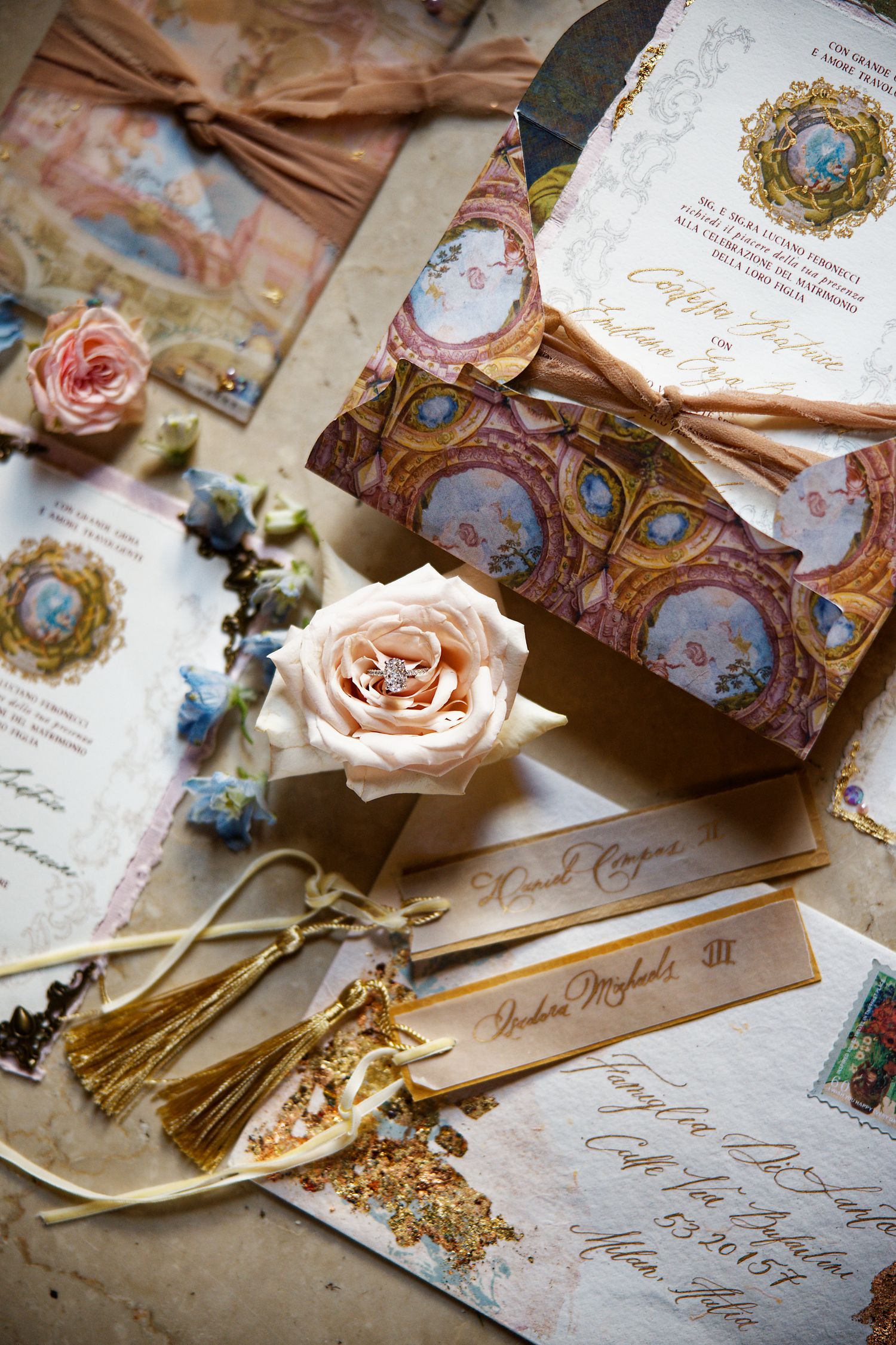 Vintage-inspired wedding invitations with peacock motifs, roses and golden details.