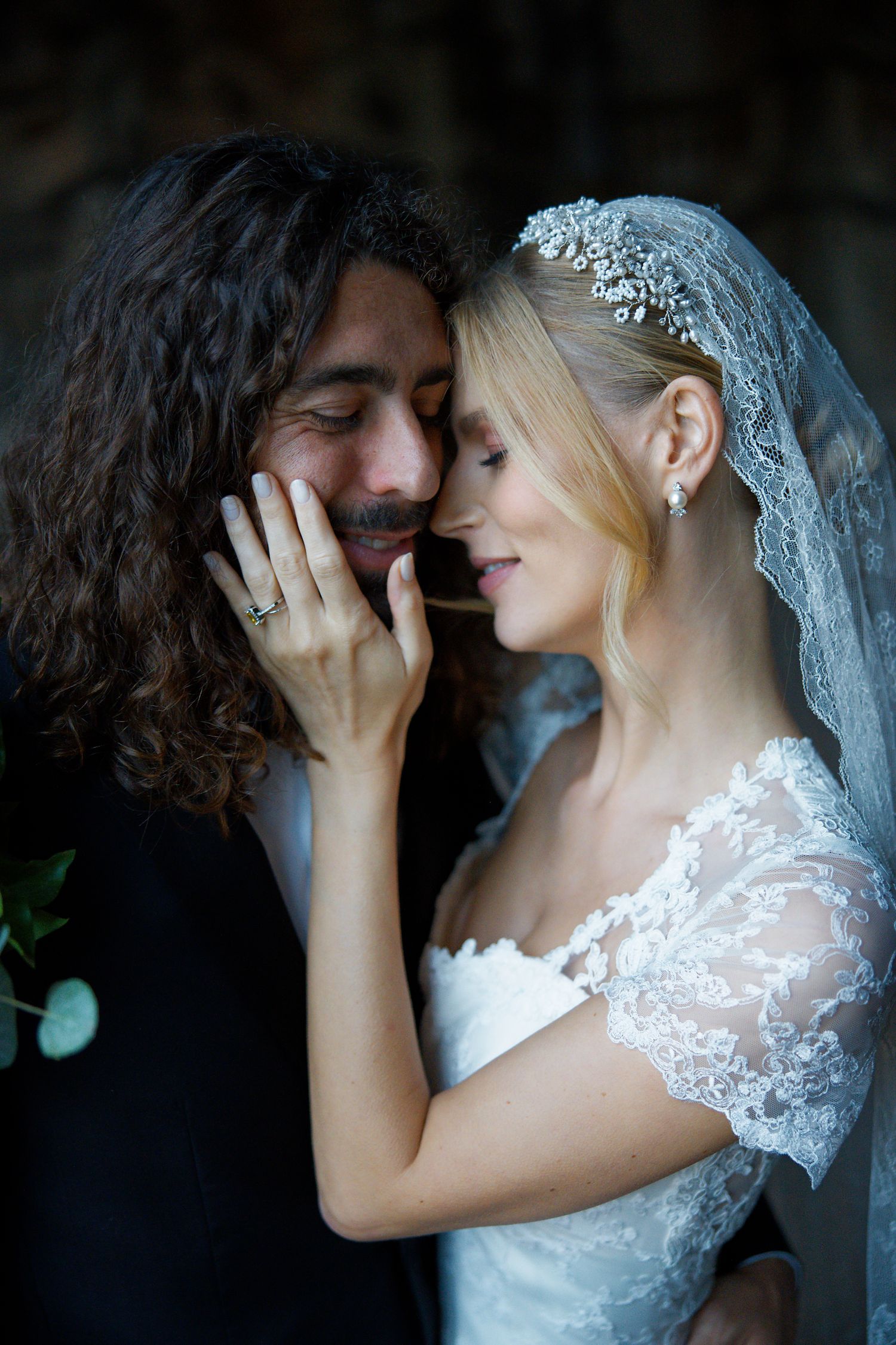 A romantic close-up portrait of newlyweds sharing an intimate moment.