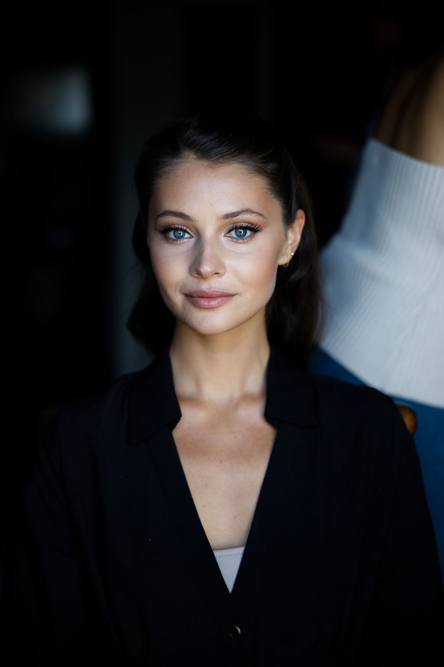 Professional portrait of a person wearing a black blazer with natural lighting and soft makeup.