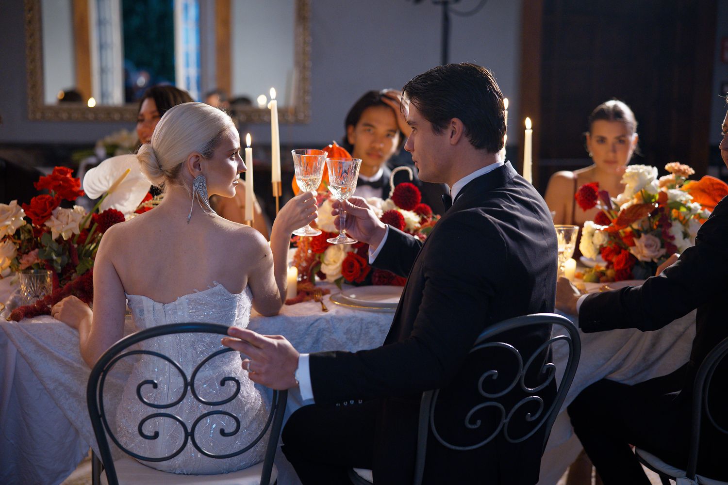A candlelit wedding reception dinner with elegant place settings and romantic ambiance.