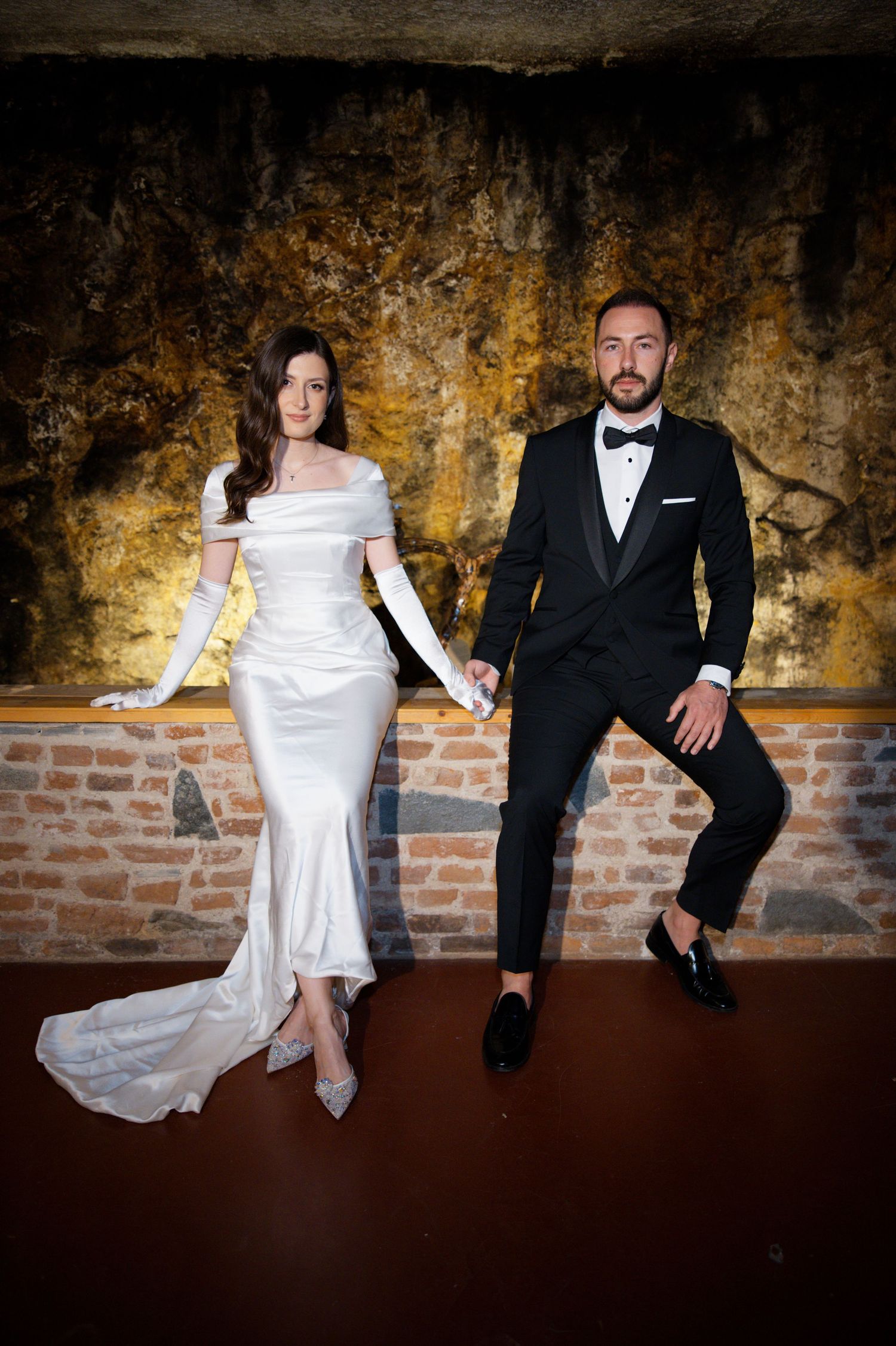 Creative wedding portrait series against rustic brick and stone wall background.