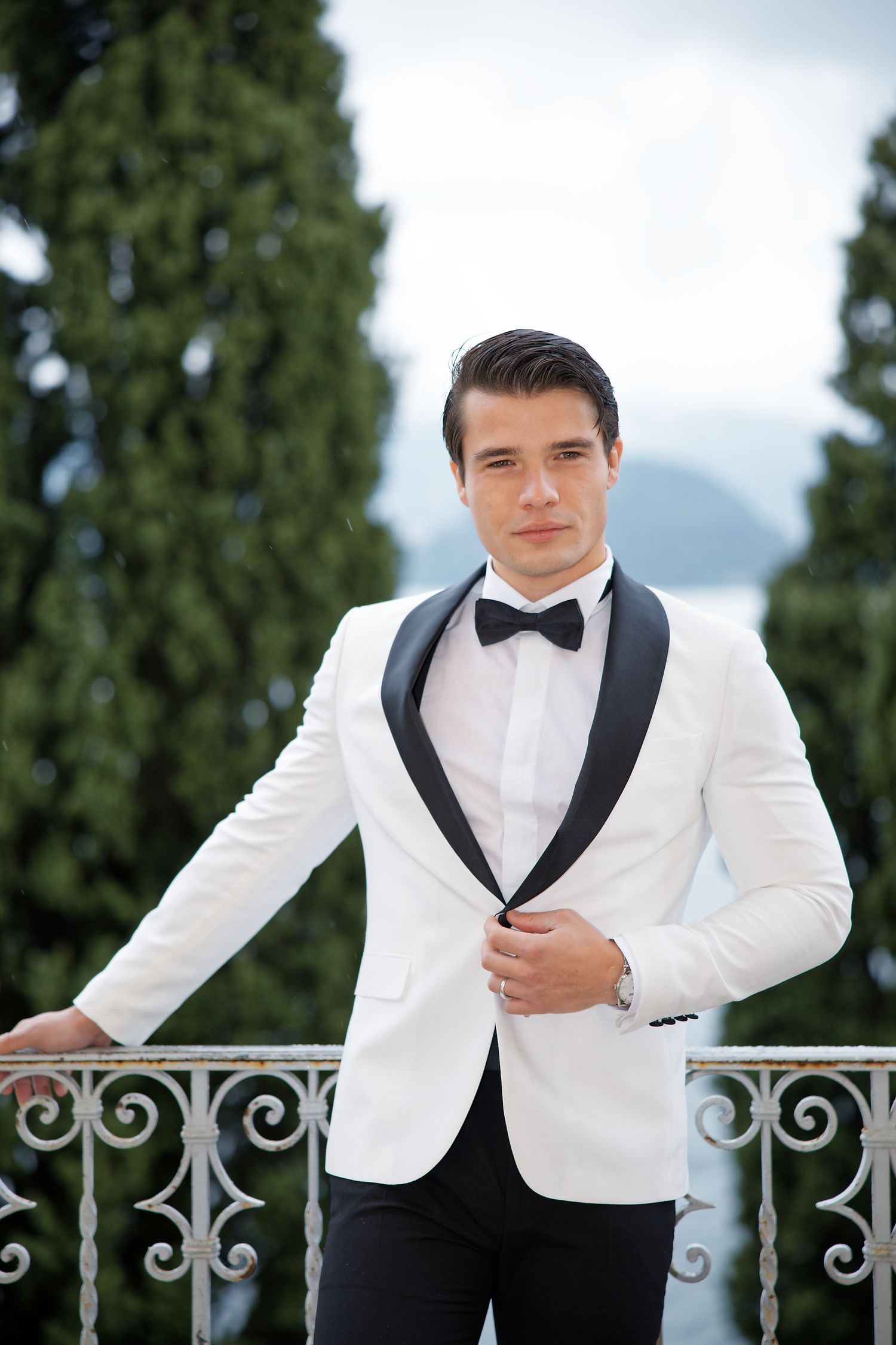 Classic white tuxedo jacket with black lapels photographed on Mediterranean terrace.