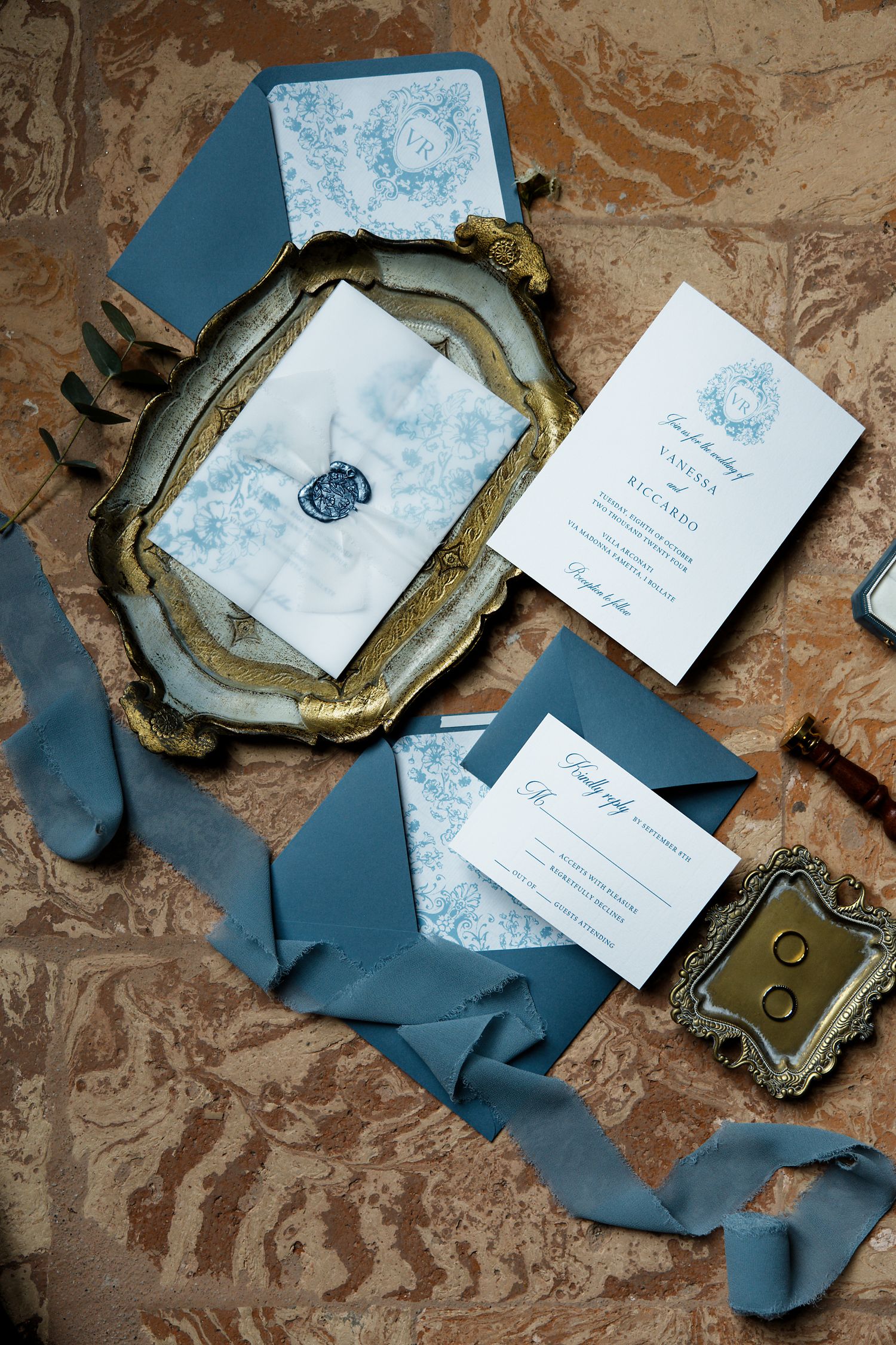 Elegant wedding invitation suite in dusty blue and white with vintage gold tray and silk ribbons.