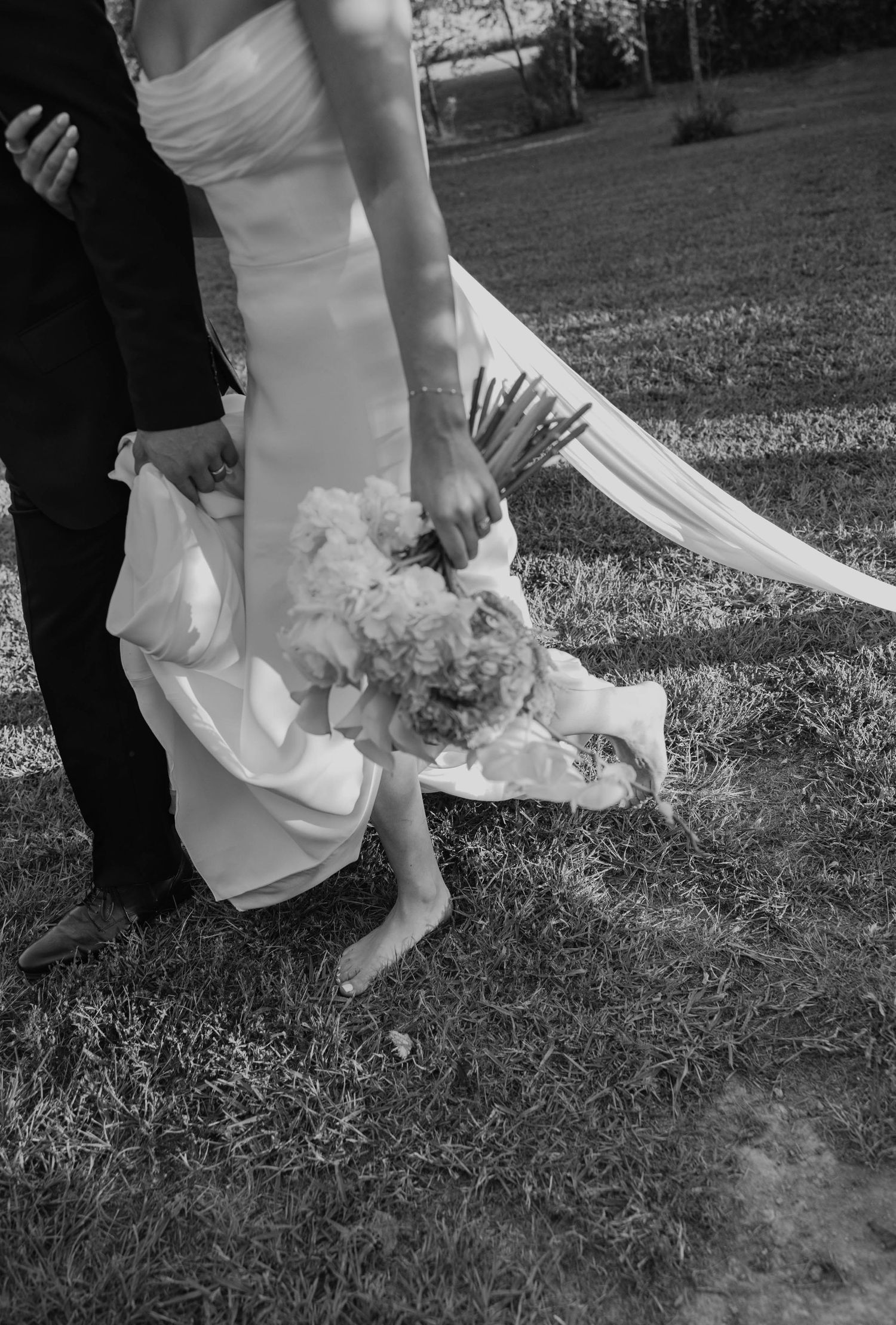 Birmingham Alabama Photographer capturing bride and groom walking in a field, at Iris Woods Venue in Nashville, Tennessee