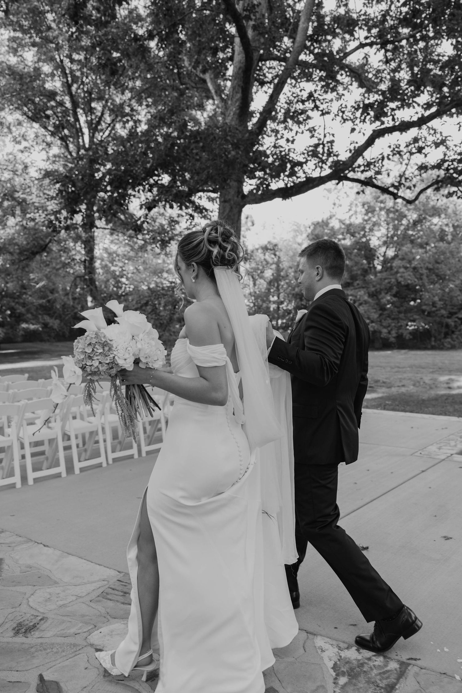 Birmingham Alabama Photographer capturing bride and groom walking to ceremony space, at Iris Woods Venue in Nashville, Tennessee