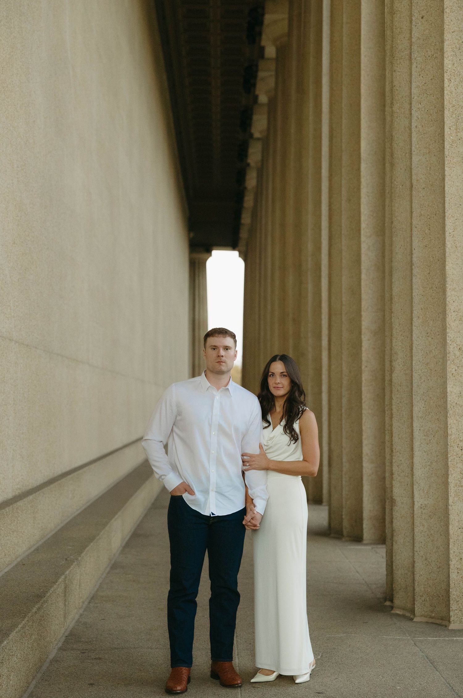 Birmingham Alabama Photographer capturing an engagement session of a couple posing and smiling  in Nashville Tennessee at the Parthenon