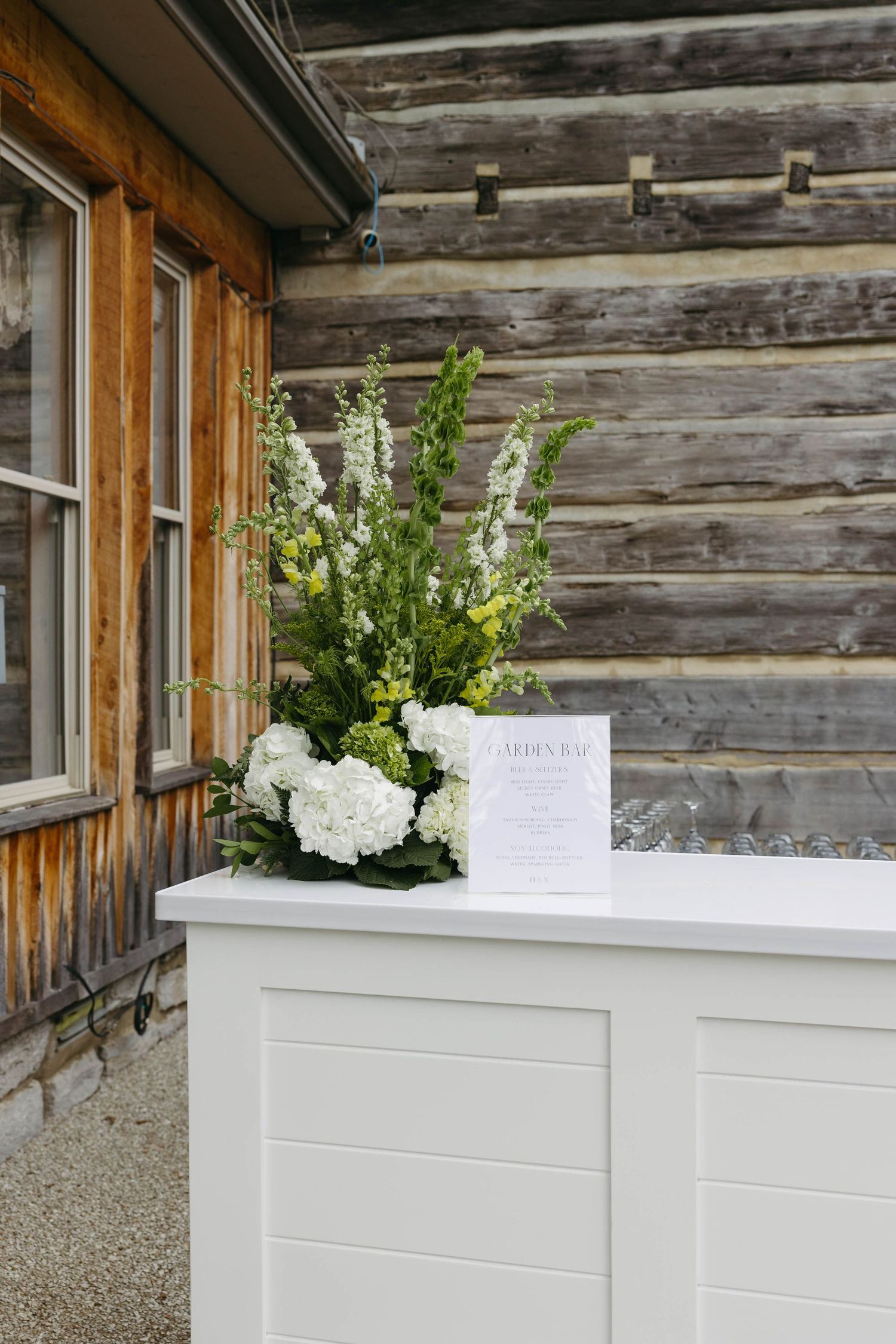 Birmingham Alabama Photographer capturing details of bar floral arrangement at reception space, at Iris Woods Venue in Nashville, Tennessee