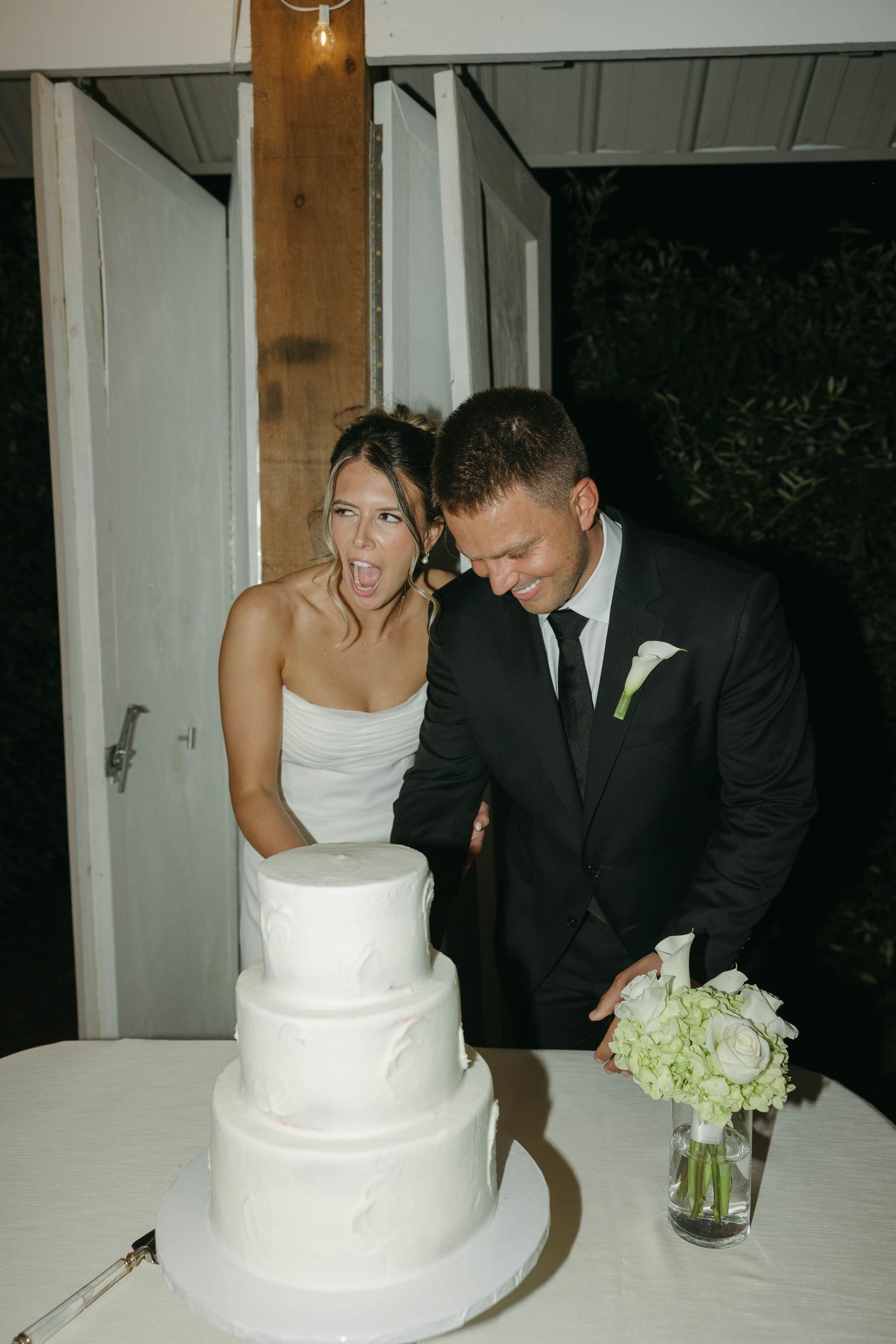 Birmingham Alabama Photographer capturing bride and groom cutting their cake in the reception, at Iris Woods Venue in Nashville, Tennessee