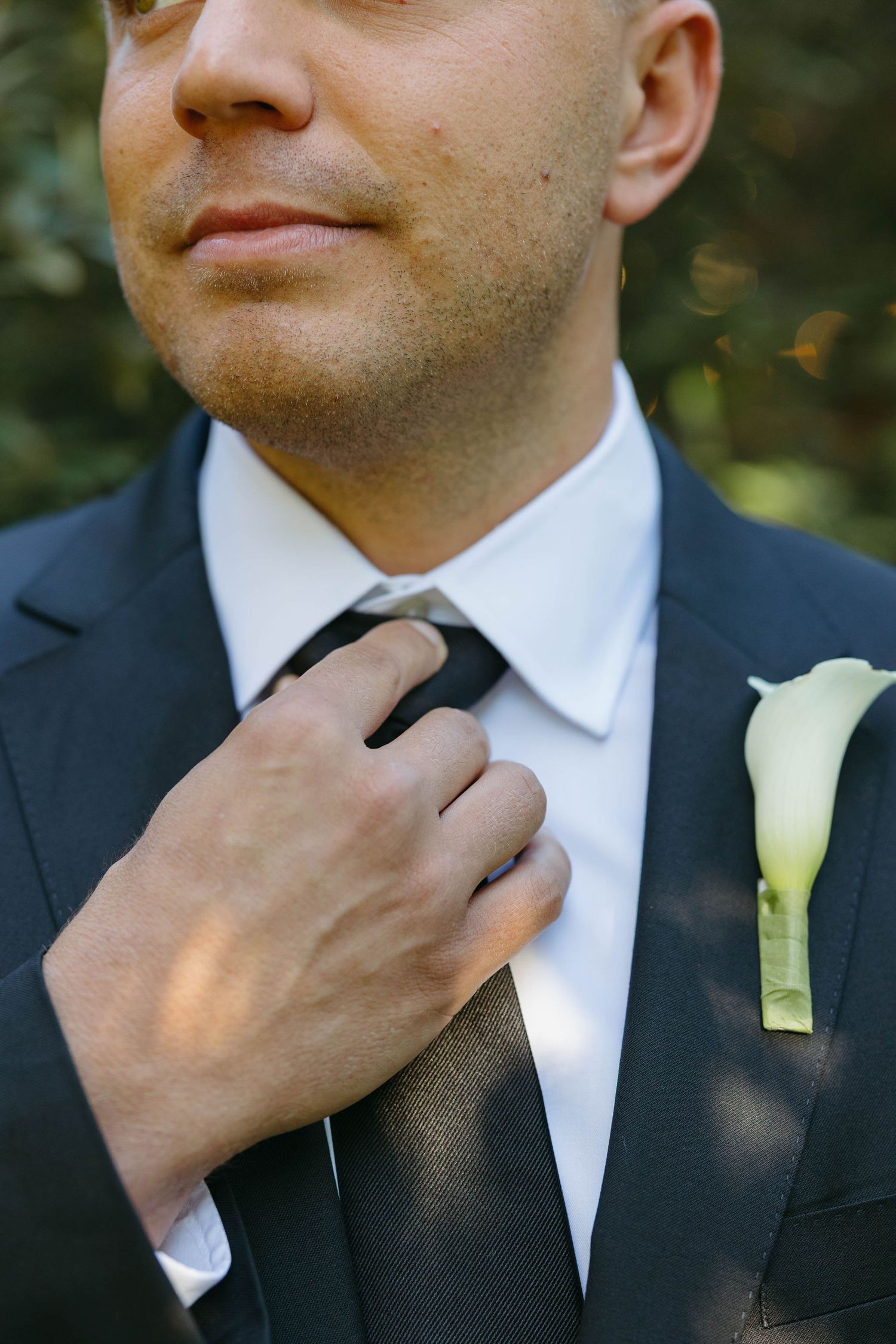 Birmingham Alabama Photographer capturing groom holding tie, at Iris Woods Venue in Nashville, Tennessee