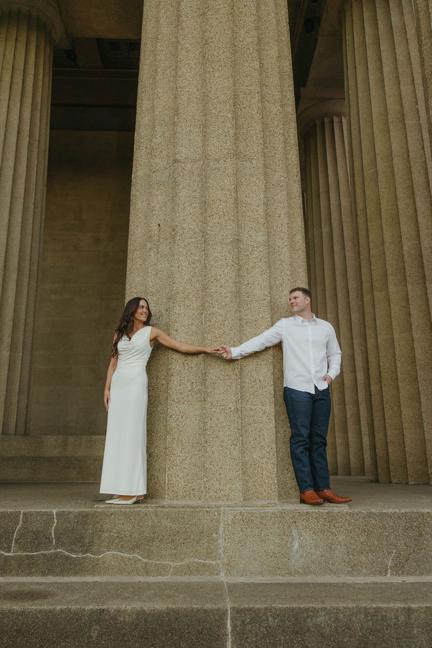Birmingham Alabama Photographer capturing an engagement session of a couple holding hands in Nashville Tennessee at the Parthenon