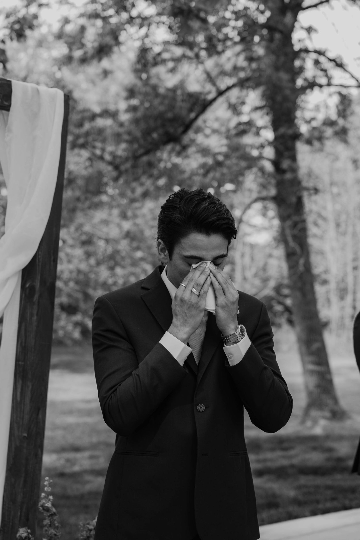 Birmingham Alabama Photographer capturing groom crying at the ceremony space, at Iris Woods Venue in Nashville, Tennessee