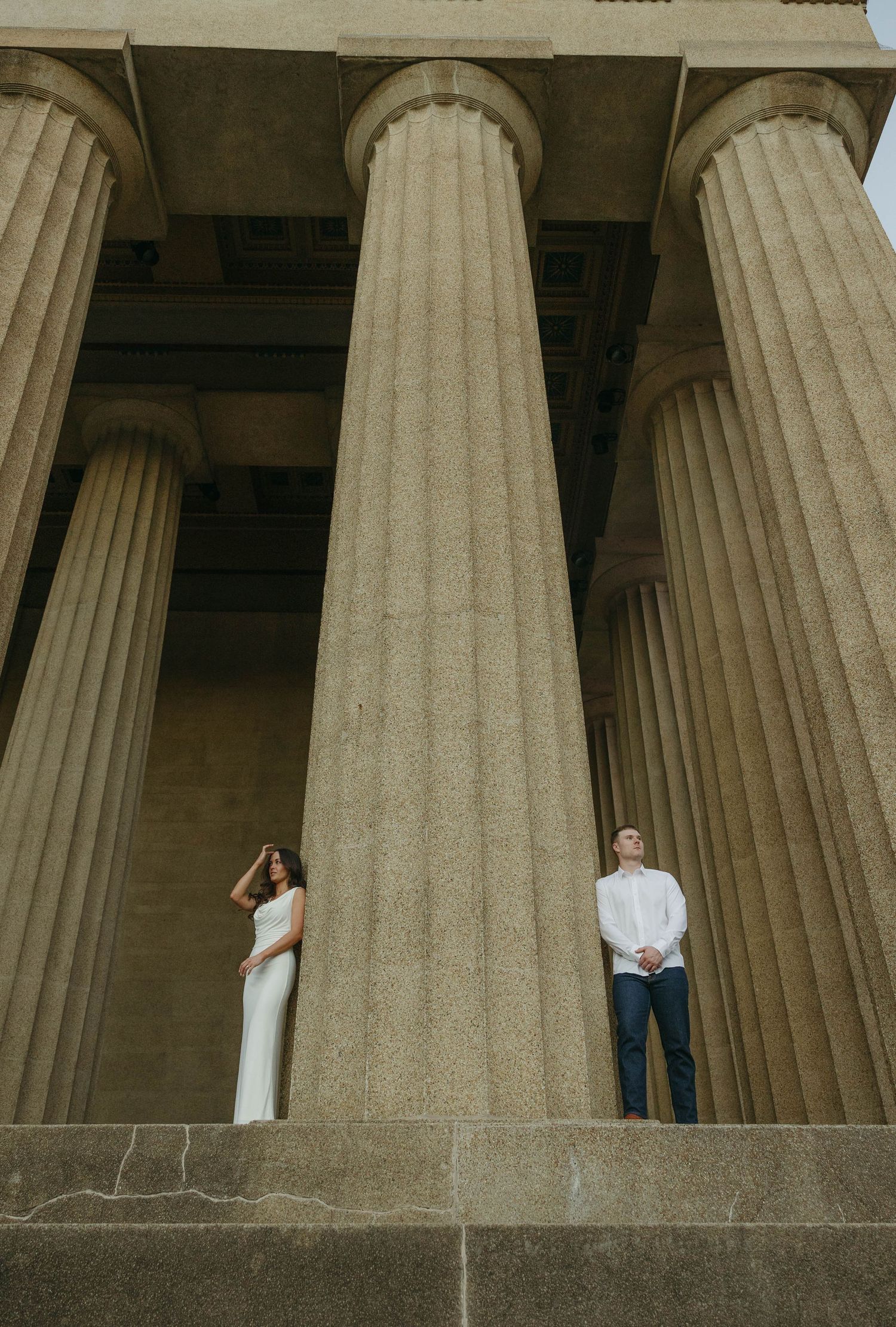 Birmingham Alabama Photographer capturing an engagement session of a couple posing by a column in Nashville Tennessee at the Parthenon