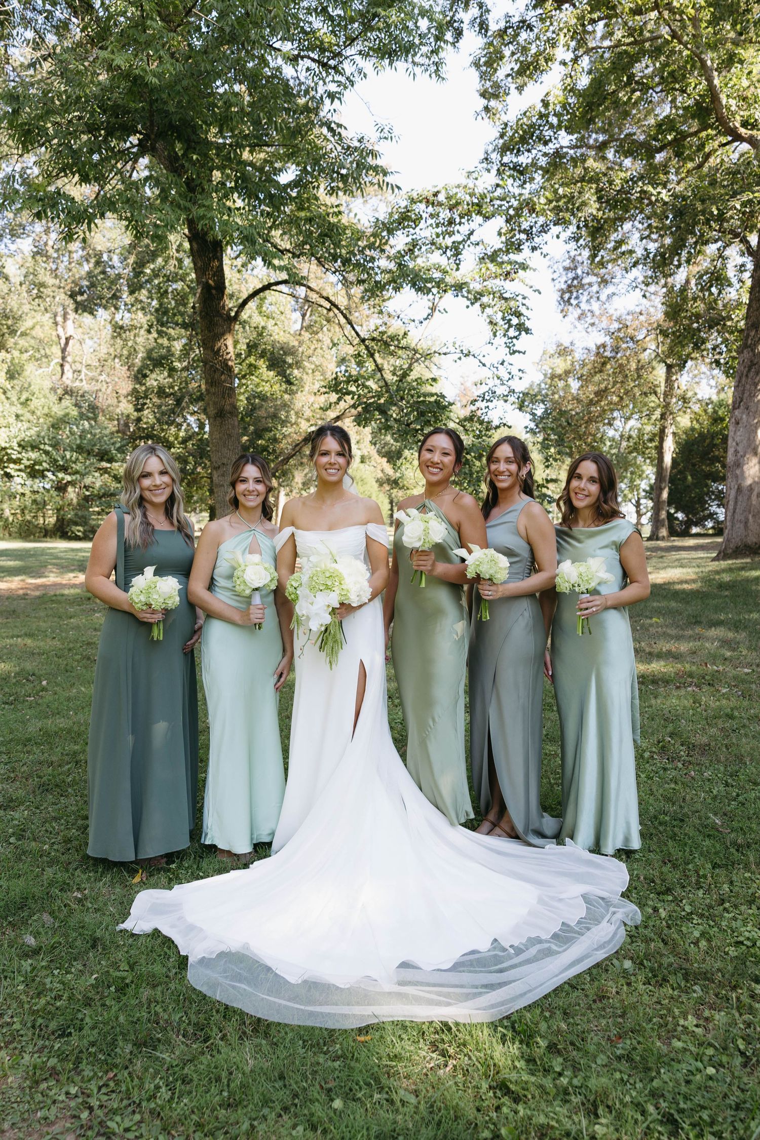 Birmingham Alabama Photographer capturing bride and bridesmaids posing with their flowers at Iris Woods Venue in Nashville, Tennessee