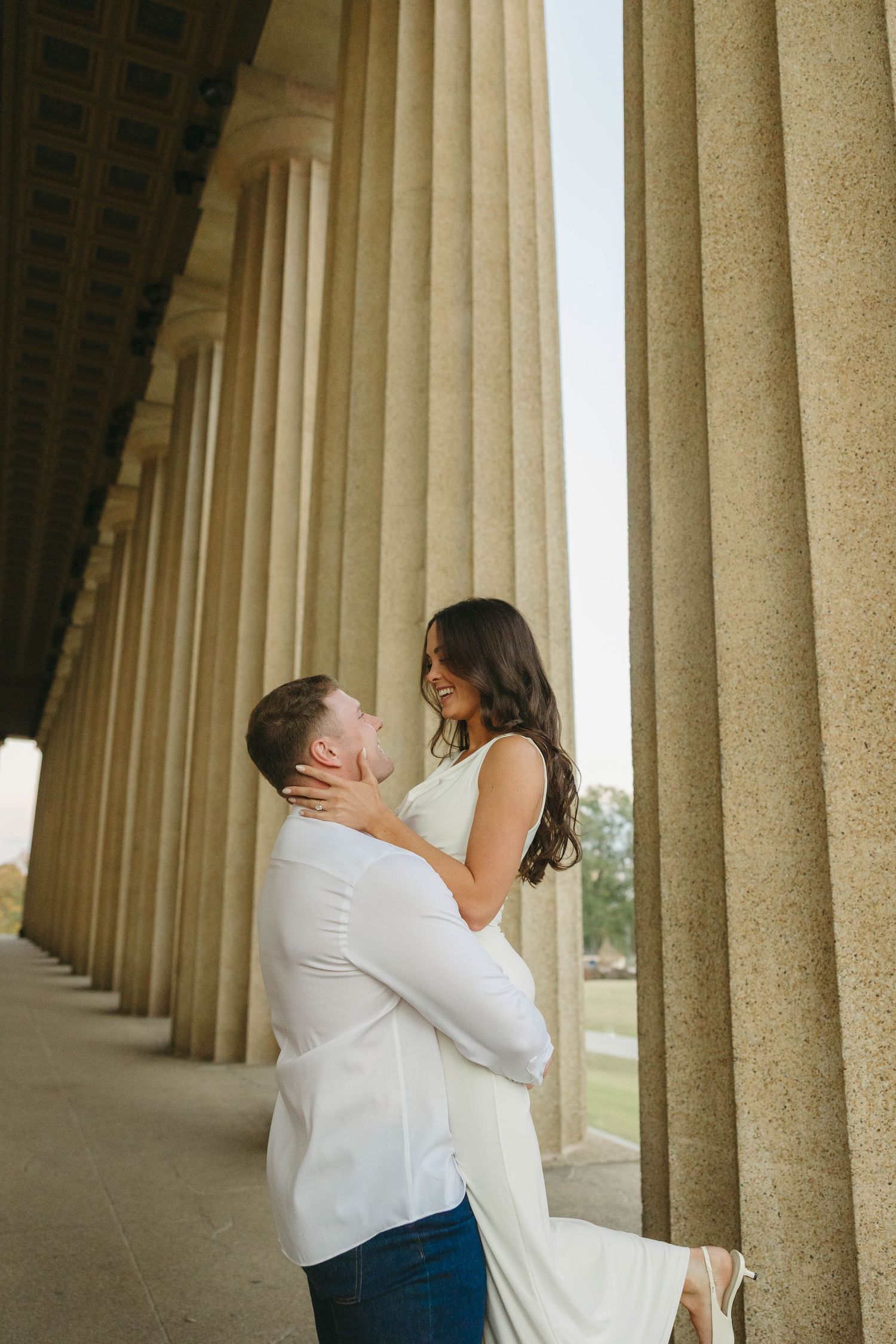 Birmingham Alabama Photographer capturing an engagement session of a couple posing and smiling  in Nashville Tennessee at the Parthenon