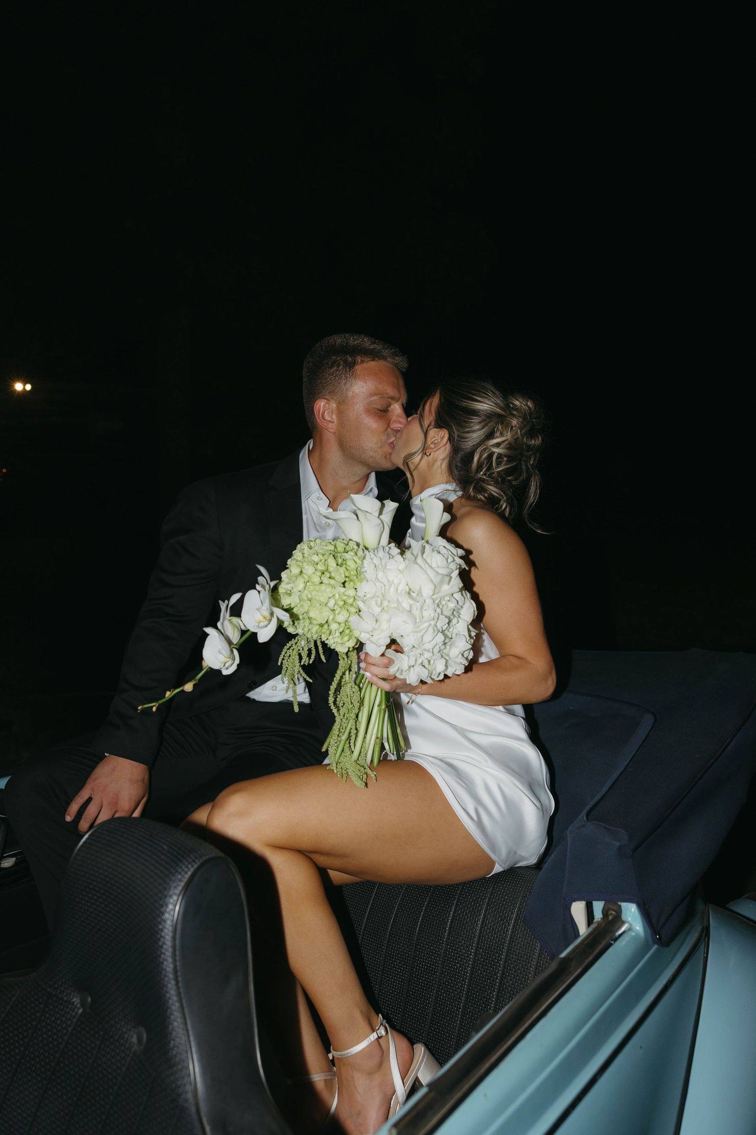 Birmingham Alabama Photographer capturing a couple kissing in a Volkswagen Beetle, at Iris Woods Venue in Nashville, Tennessee
