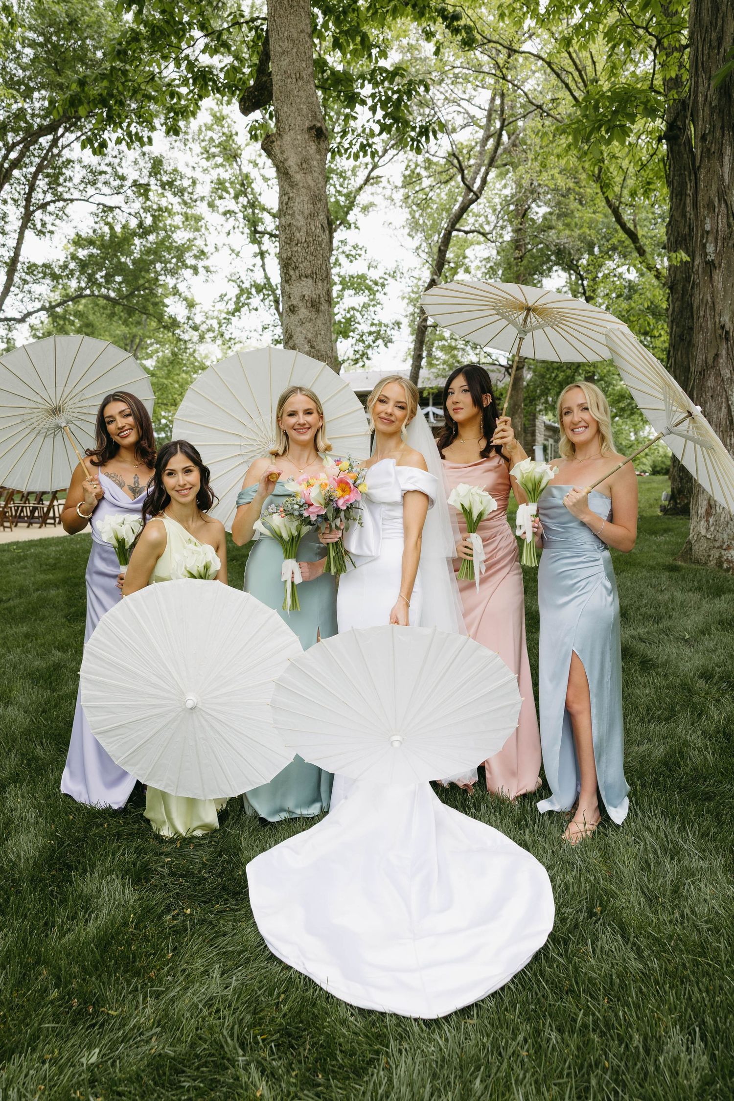 bride with her bridesmaids and their parasols