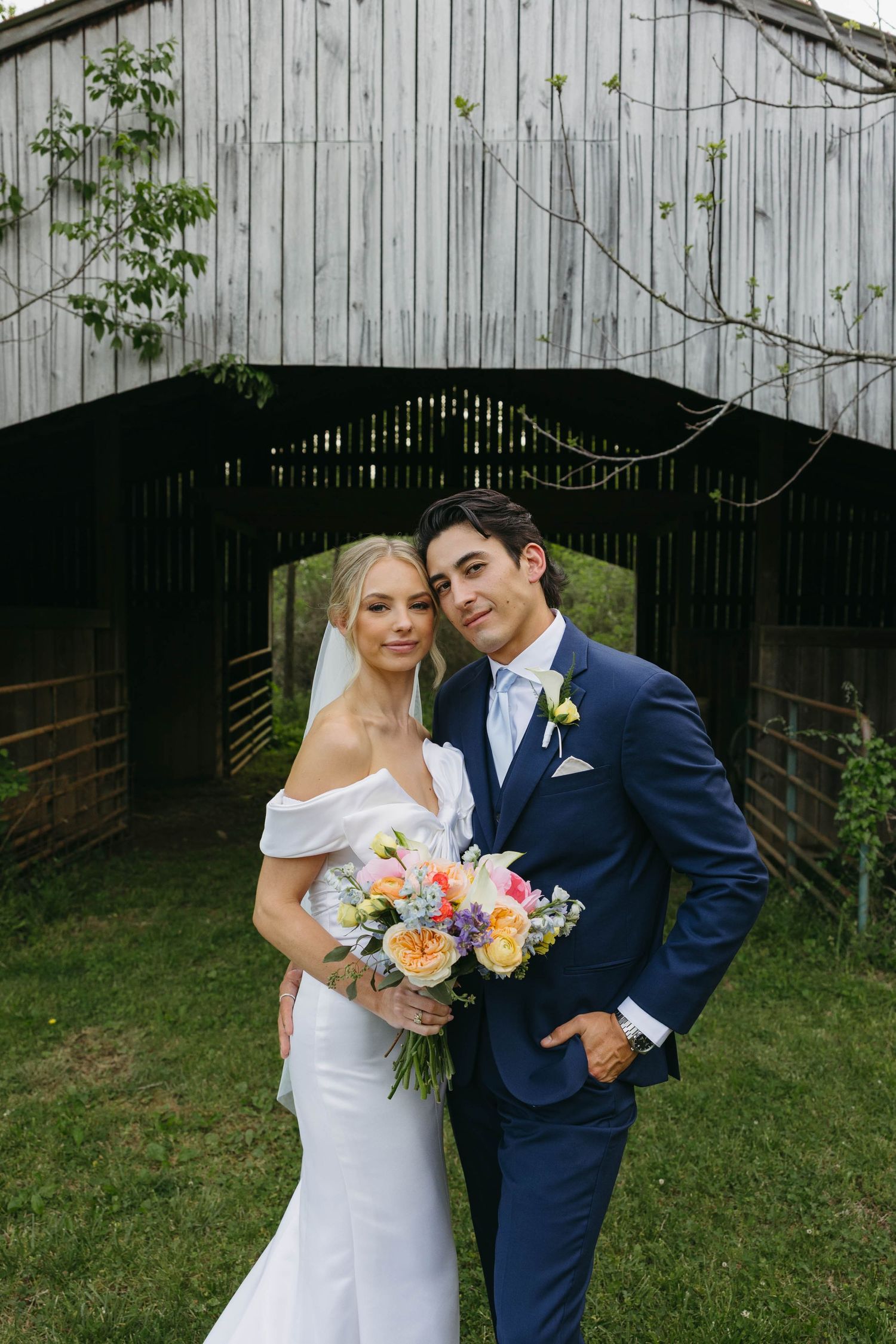 Birmingham Alabama Photographer capturing bride and groom posing in a field, at Iris Woods Venue in Nashville, Tennessee