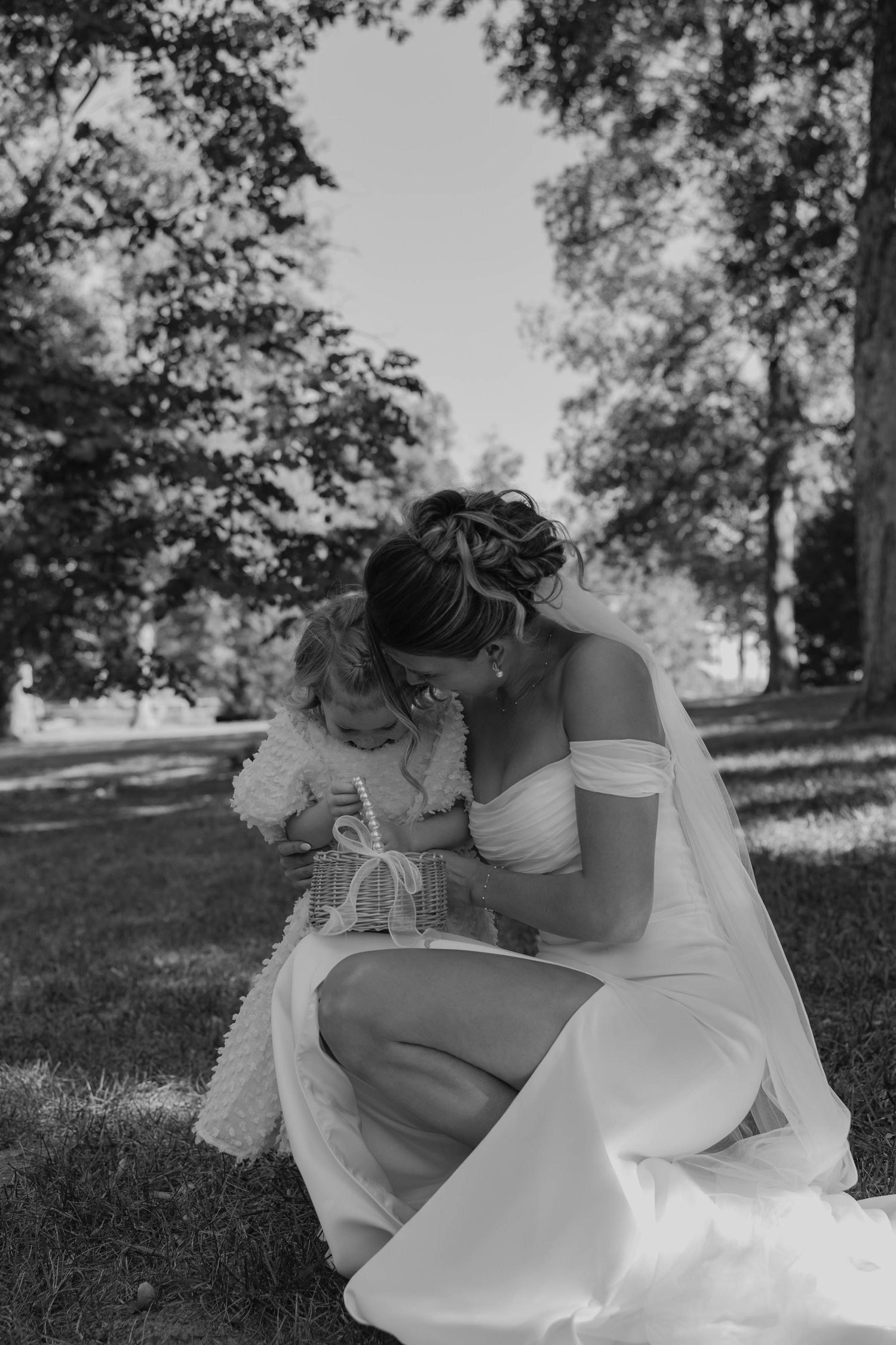 Birmingham Alabama Photographer capturing bride posing with her flower girl, at Iris Woods Venue in Nashville, Tennessee