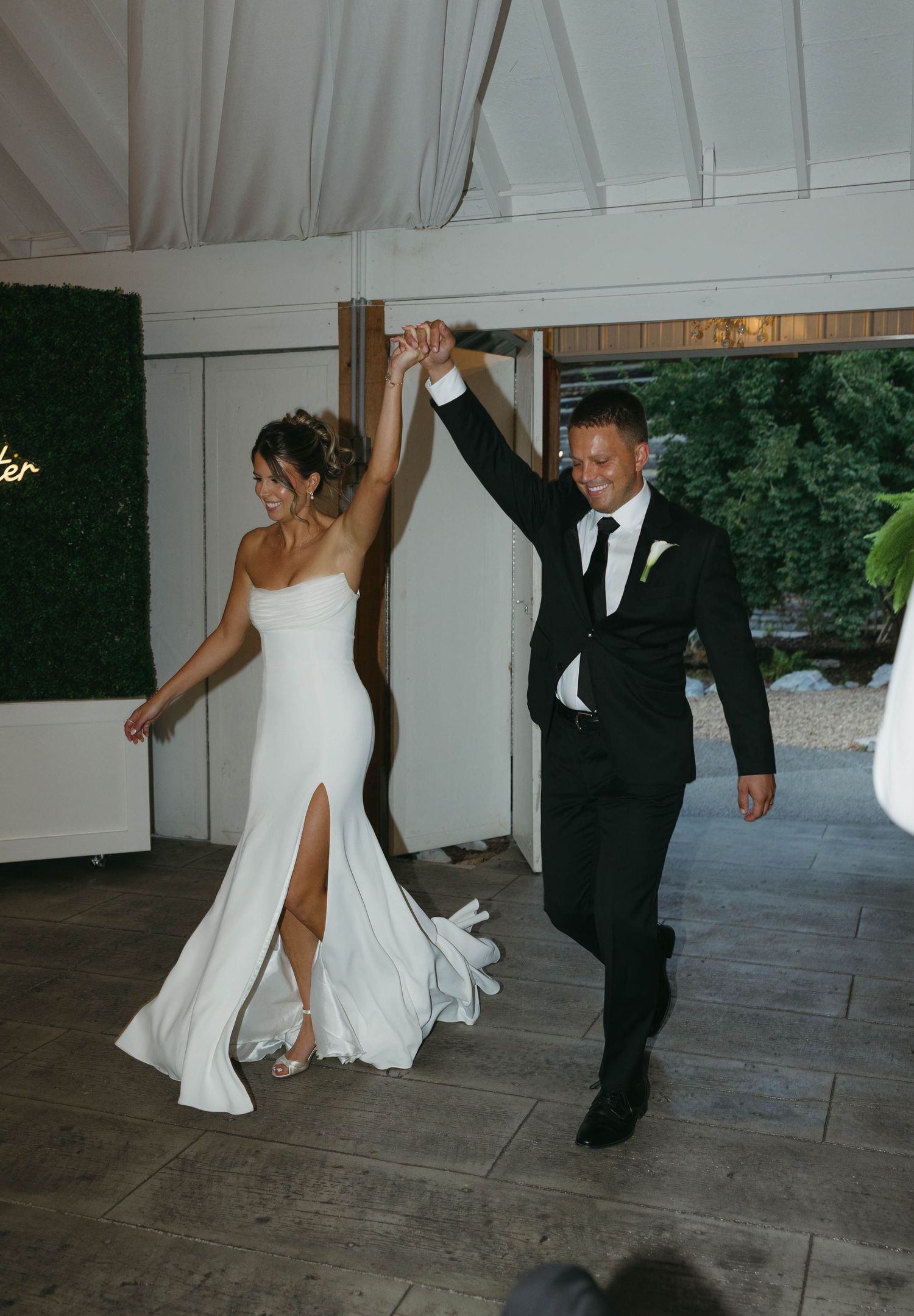 Birmingham Alabama Photographer capturing bride and groom entering their reception, at Iris Woods Venue in Nashville, Tennessee