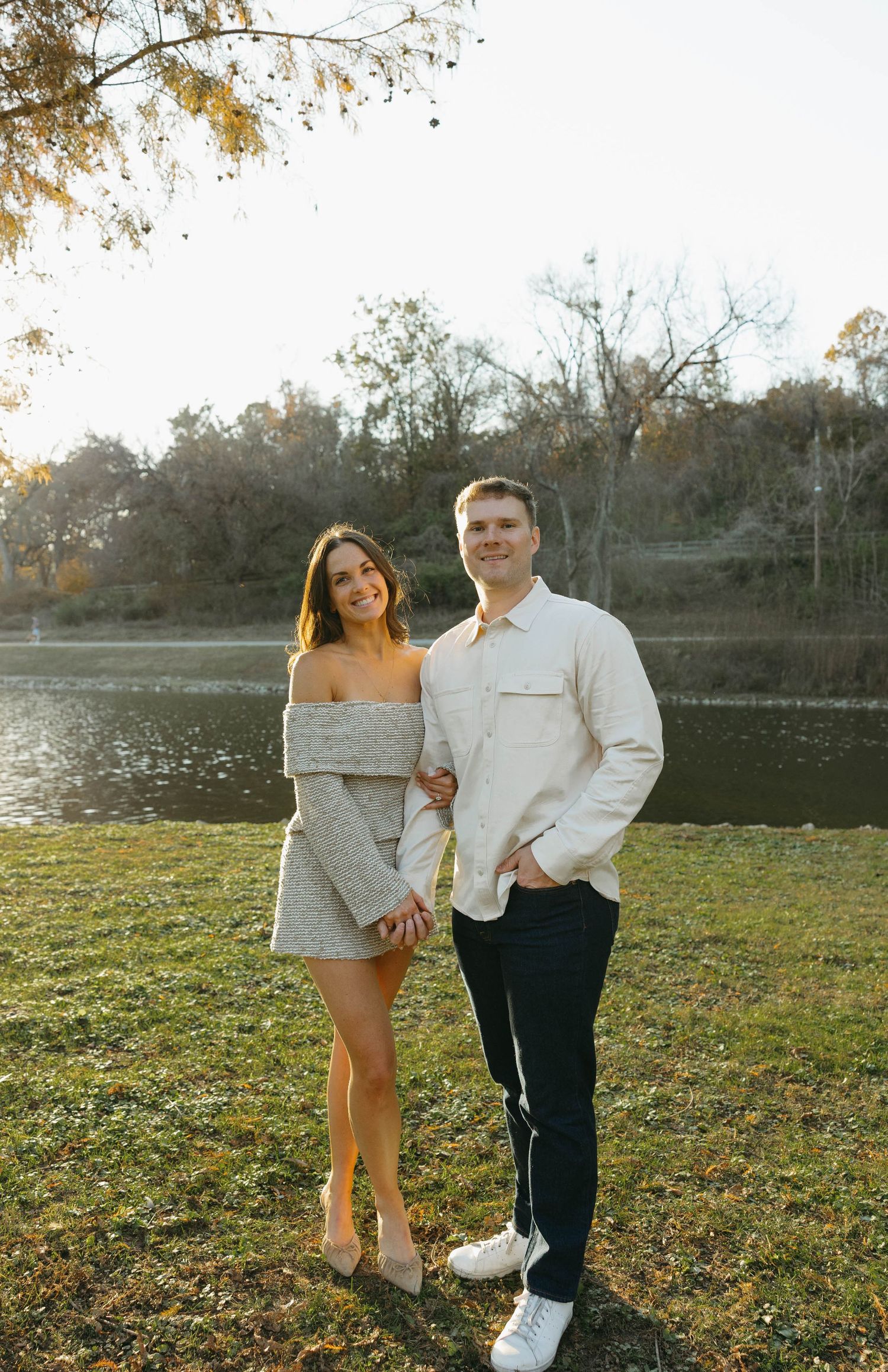 Birmingham Alabama Photographer capturing an engagement session of a couple posing in a park by a lake in Nashville Tennessee