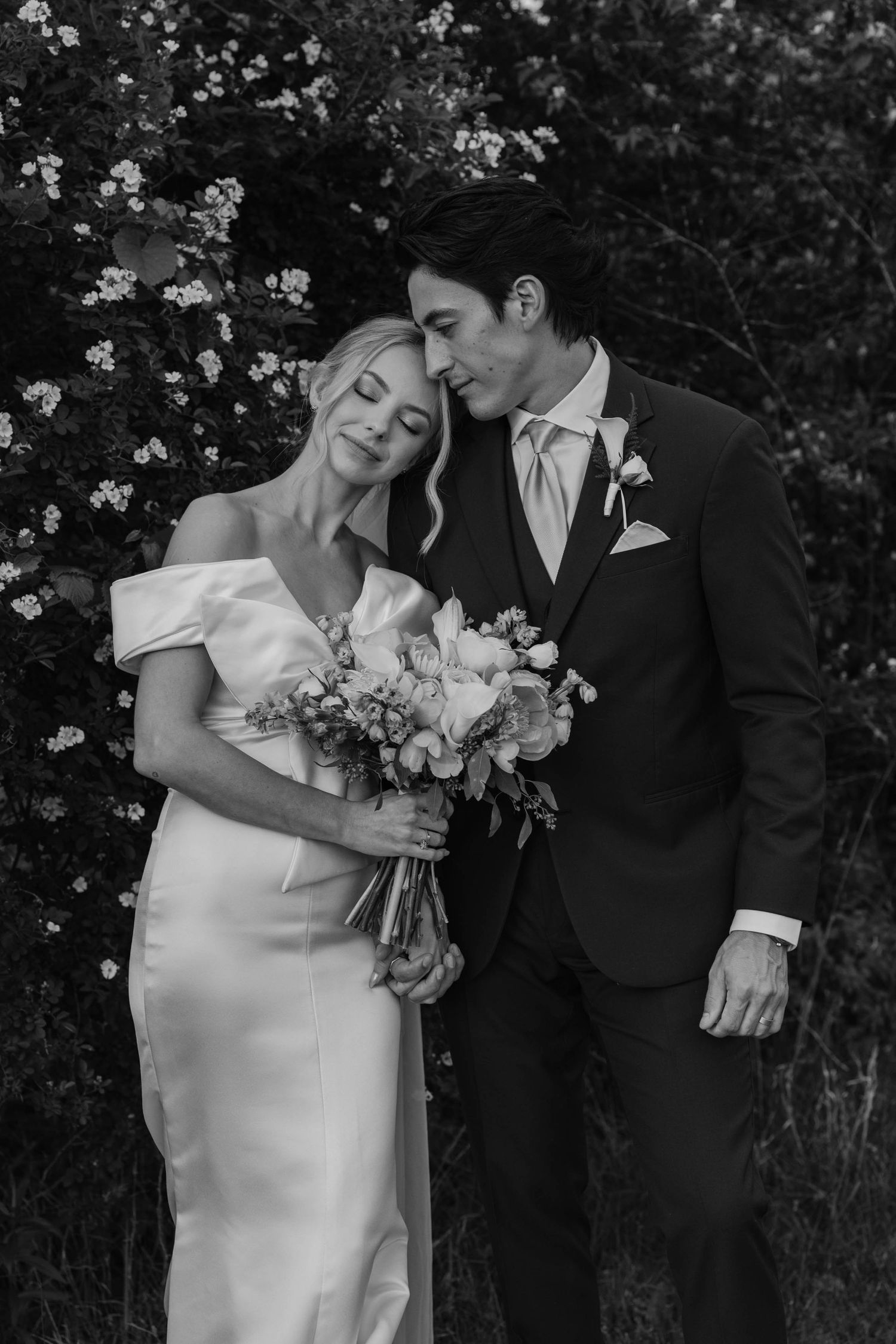 Birmingham Alabama Photographer capturing bride and groom posing, in a field, at Iris Woods Venue in Nashville, Tennessee