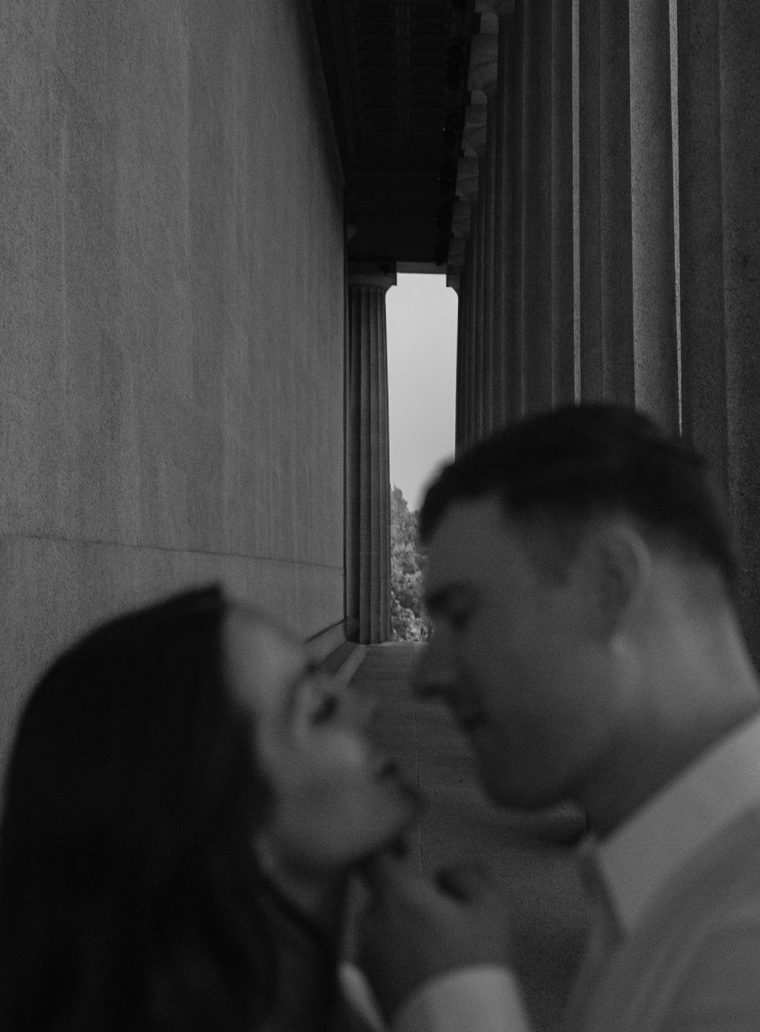 Birmingham Alabama Photographer capturing an engagement session of a couple slowly kissing in Nashville Tennessee at the Parthenon