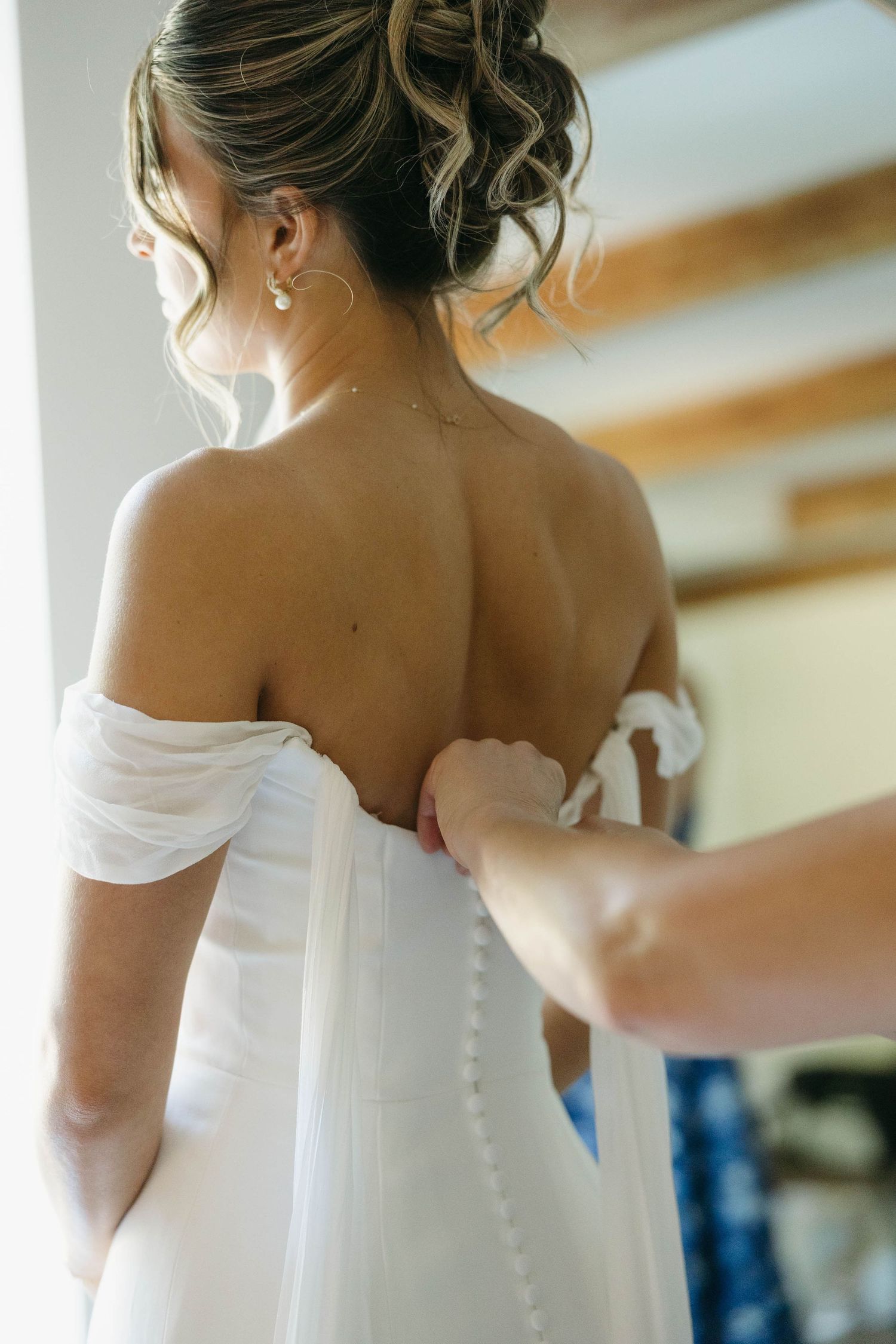 Birmingham Alabama Photographer capturing mother of bride putting on the bride's dress, at Iris Woods Venue in Nashville, Tennessee