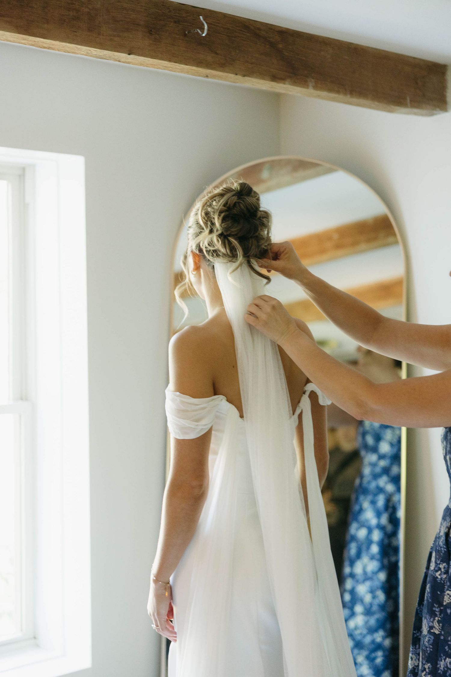 Birmingham Alabama Photographer capturing mother of bride putting on the bride's veil, at Iris Woods Venue in Nashville, Tennessee
