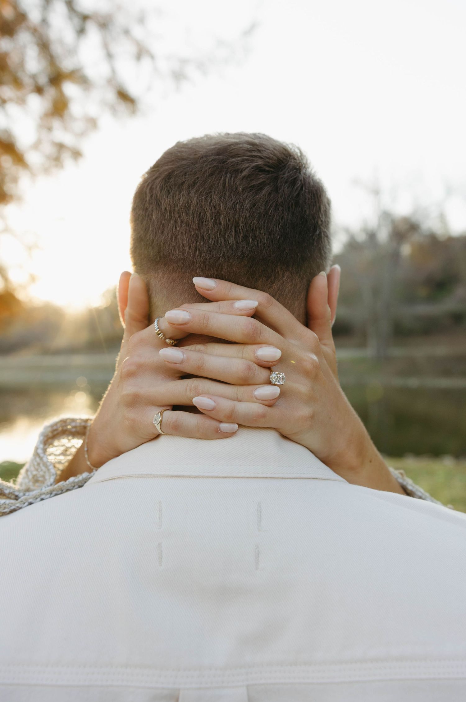 Birmingham Alabama Photographer capturing an engagement session of a couple walking in a park by a lake in Nashville Tennessee