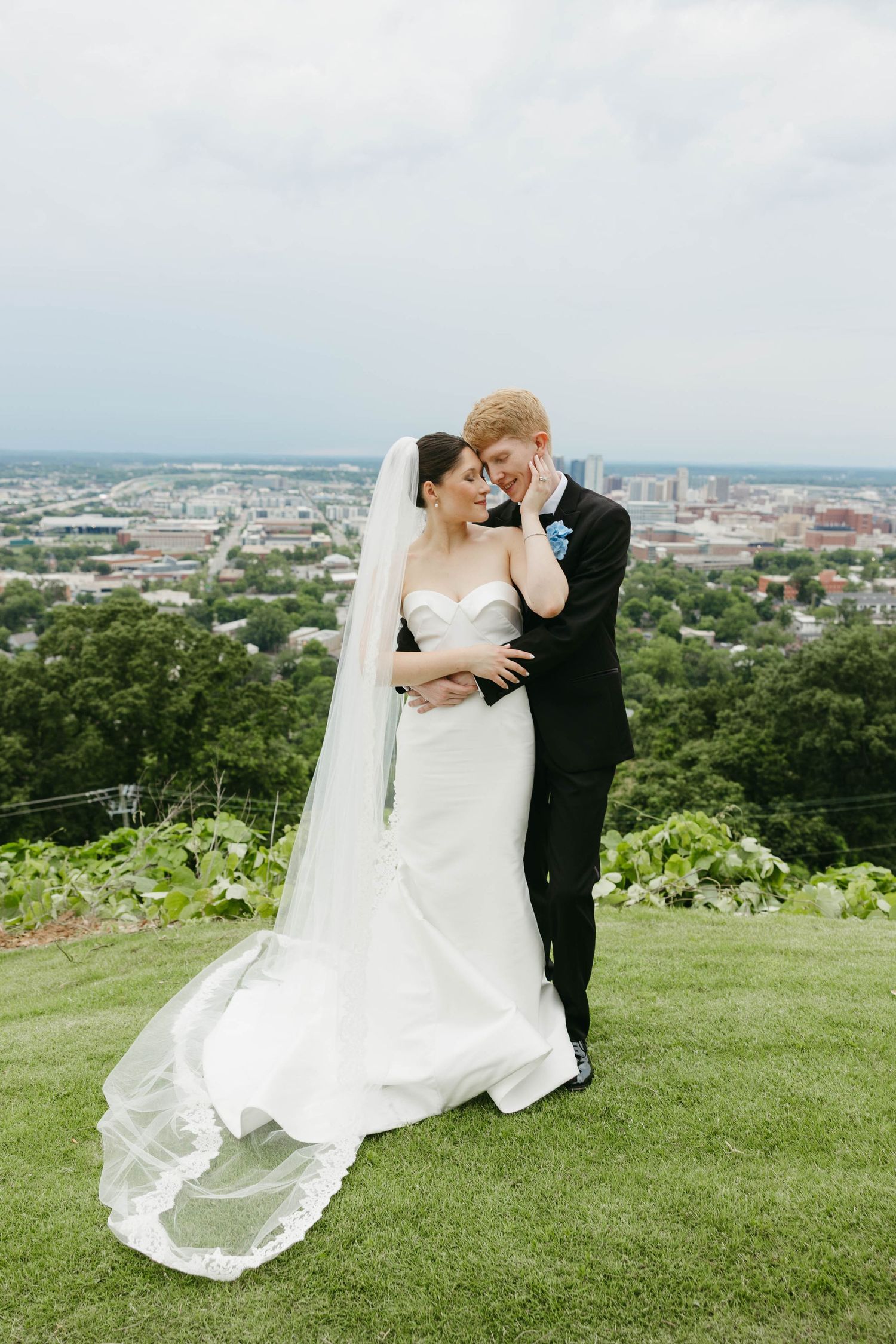 bride and groom snuggled in together at The Club overlooking Birmingham, Alabama