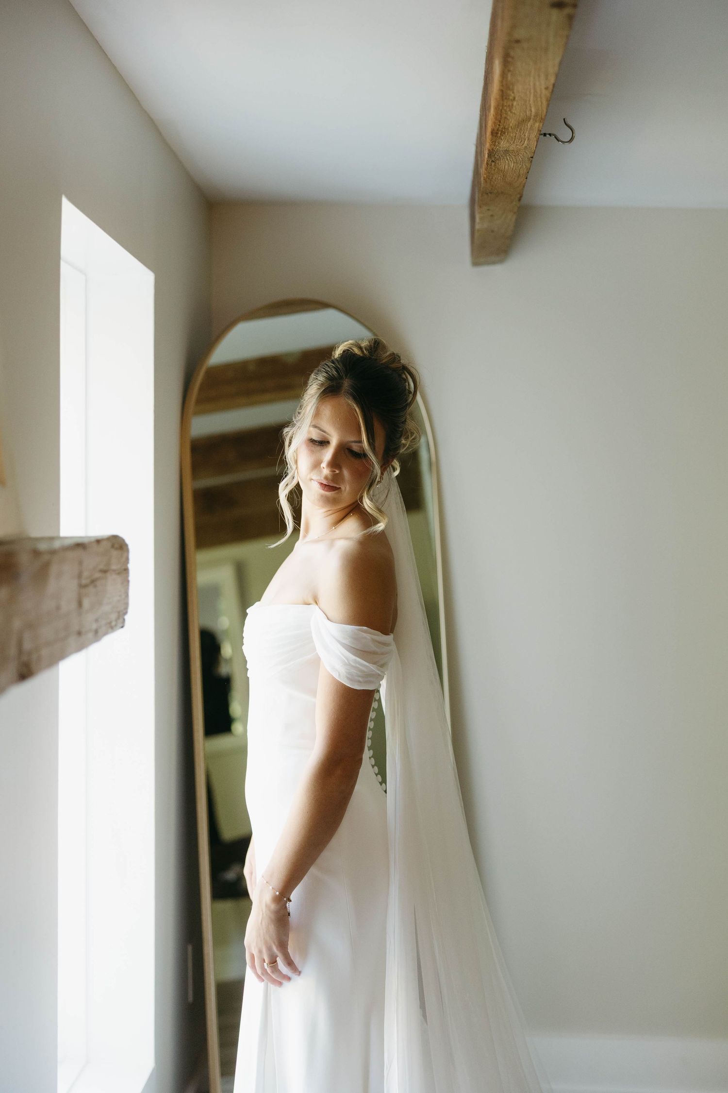 Birmingham Alabama Photographer capturing bride posing with her wedding dress, at Iris Woods Venue in Nashville, Tennessee
