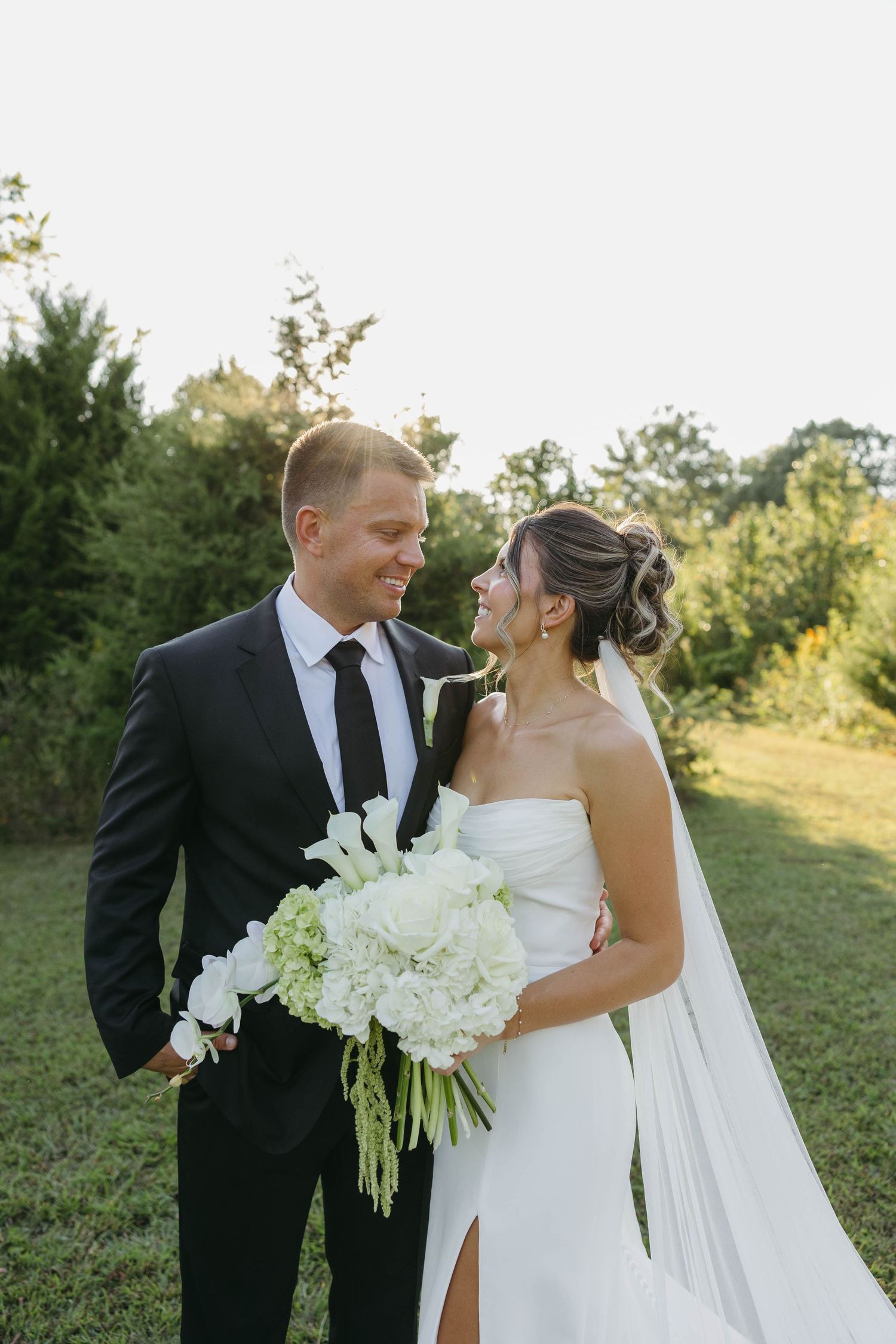 Birmingham Alabama Photographer capturing bride and groom smiling in a field, at Iris Woods Venue in Nashville, Tennessee