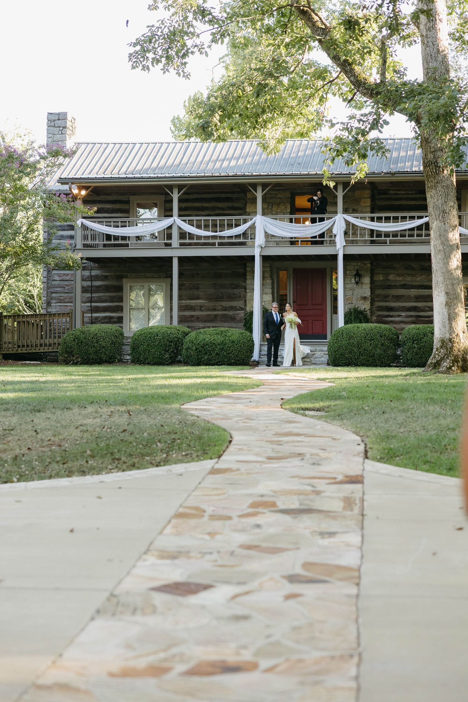 Birmingham Alabama Photographer capturing bride walking down the isle to the ceremony space, at Iris Woods Venue in Nashville, Tennessee