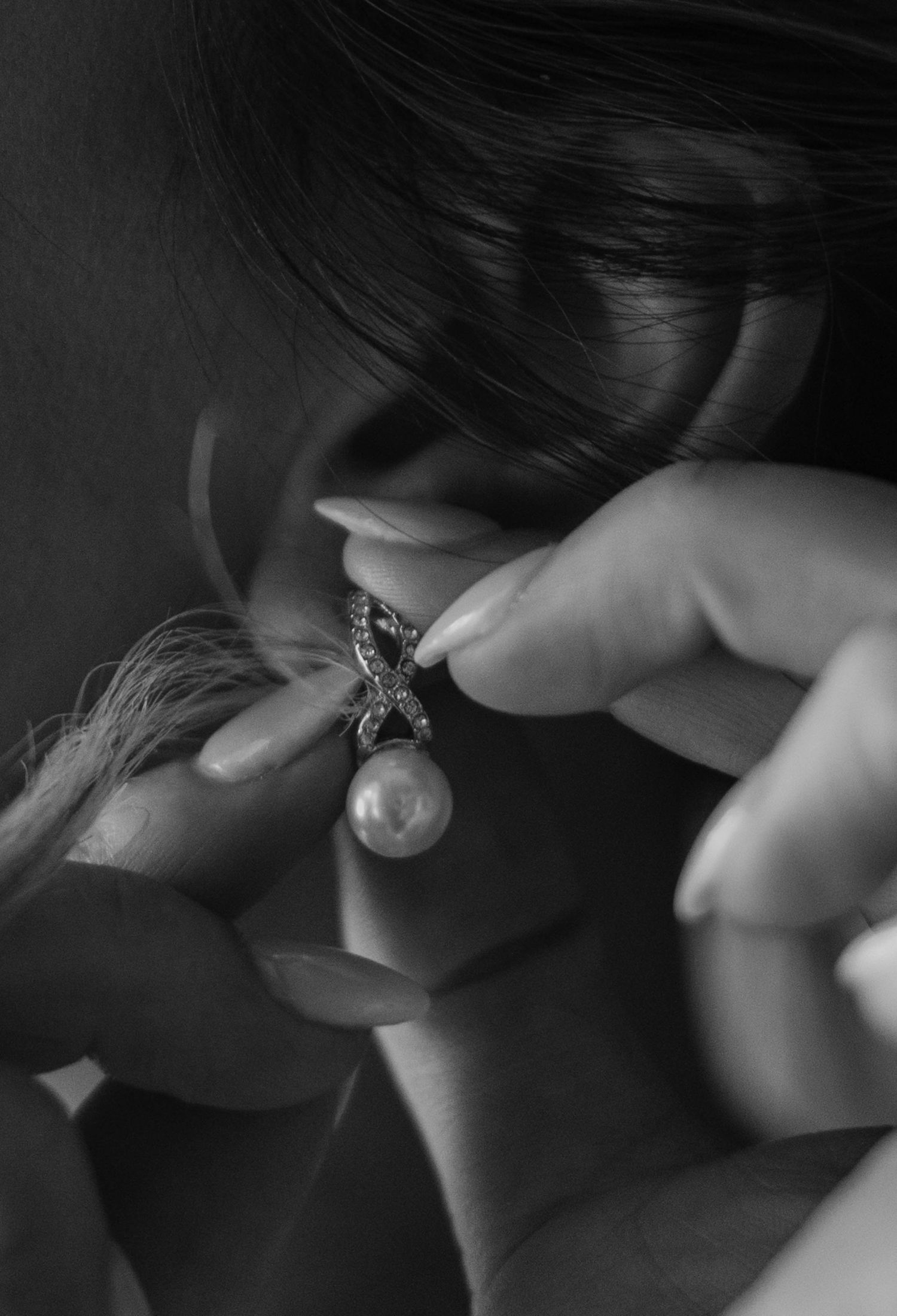 Birmingham Alabama Photographer capturing bride putting on her earrings, at Iris Woods Venue in Nashville, Tennessee