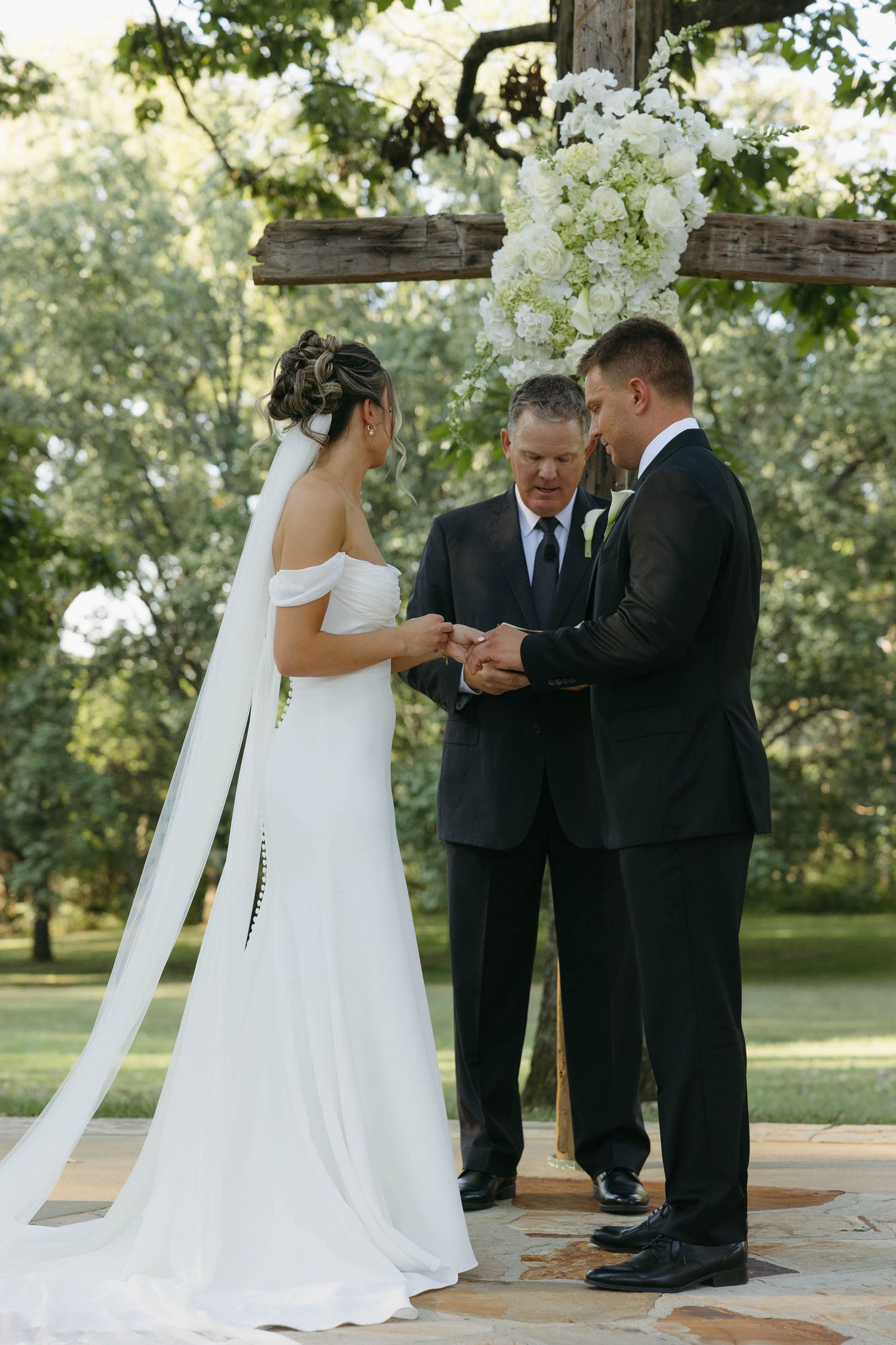 Birmingham Alabama Photographer capturing bride and groom holding hands at ceremony space, at Iris Woods Venue in Nashville, Tennessee
