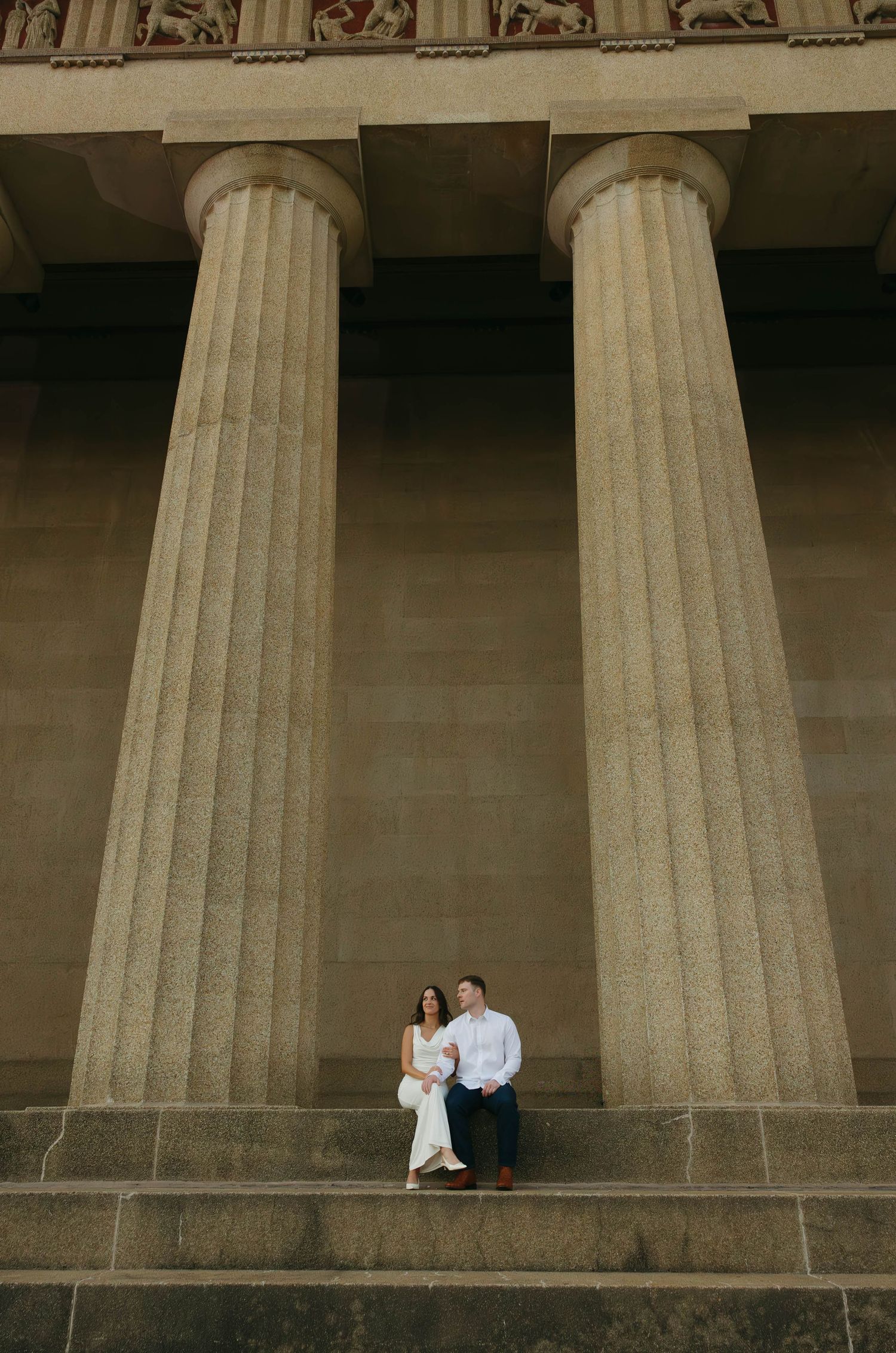 Birmingham Alabama Photographer capturing an engagement session of a couple posing and smiling  in Nashville Tennessee at the Parthenon